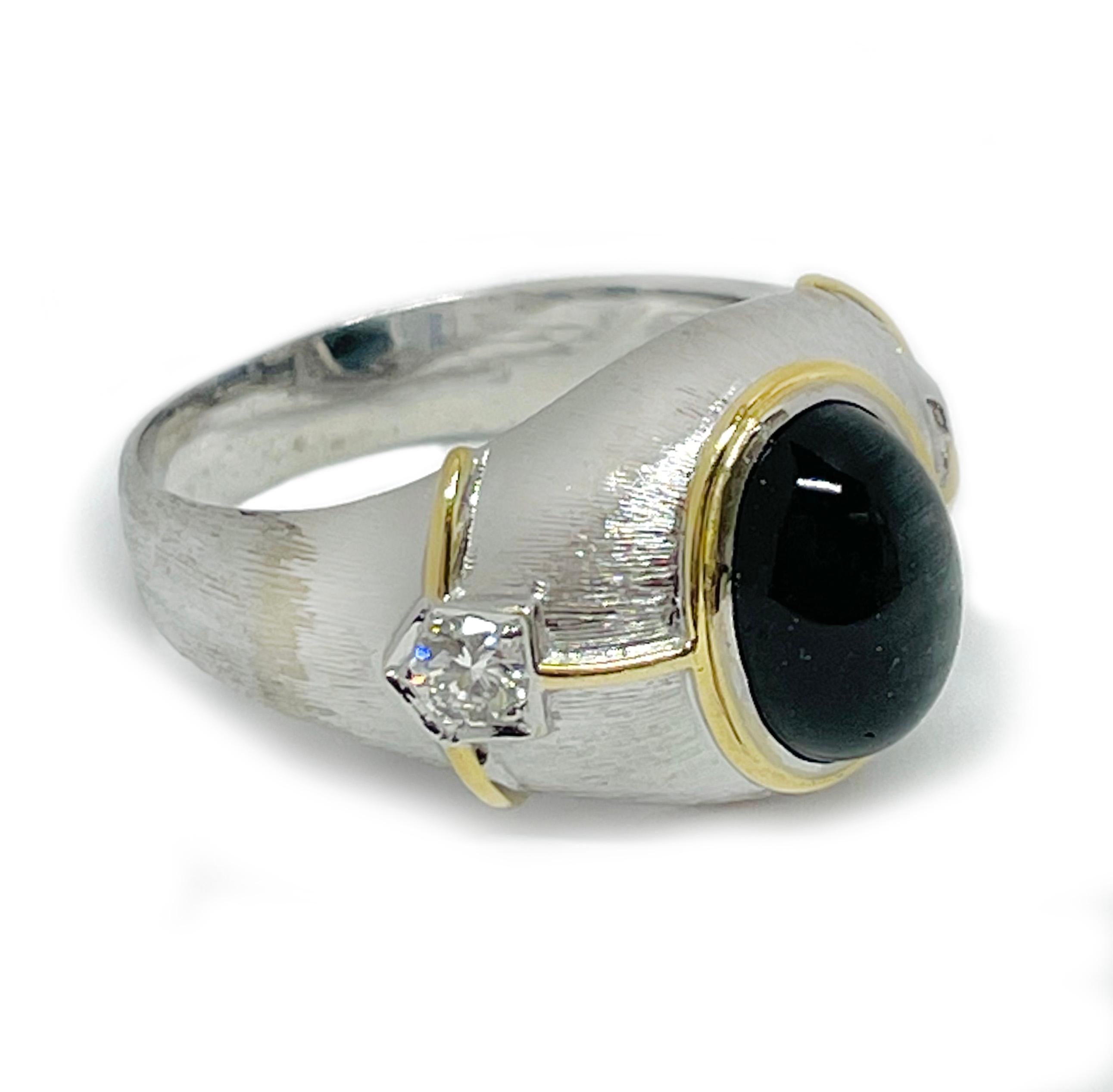 18 Karat White Gold Blue Green Cat's Eye Tourmaline Cocktail Ring with side diamonds. The sage green with hints of blue Tourmaline cabochon measures approximately 11.5mm x 8.5mm. There is a prominent single band cat's eye when light hits the