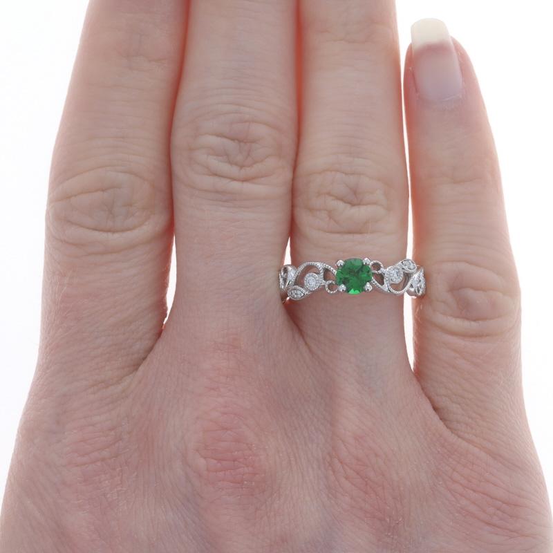 Size: 7 3/4
Sizing Fee: Up 2 sizes for $35 or Down 2 sizes for $30

Metal Content: 14k White Gold

Stone Information
Natural Chrome Tourmaline
Carat(s): .44ct
Cut: Round
Color: Green

Natural Diamonds
Carat(s): .10ctw
Cut: Round Brilliant
Color: G -