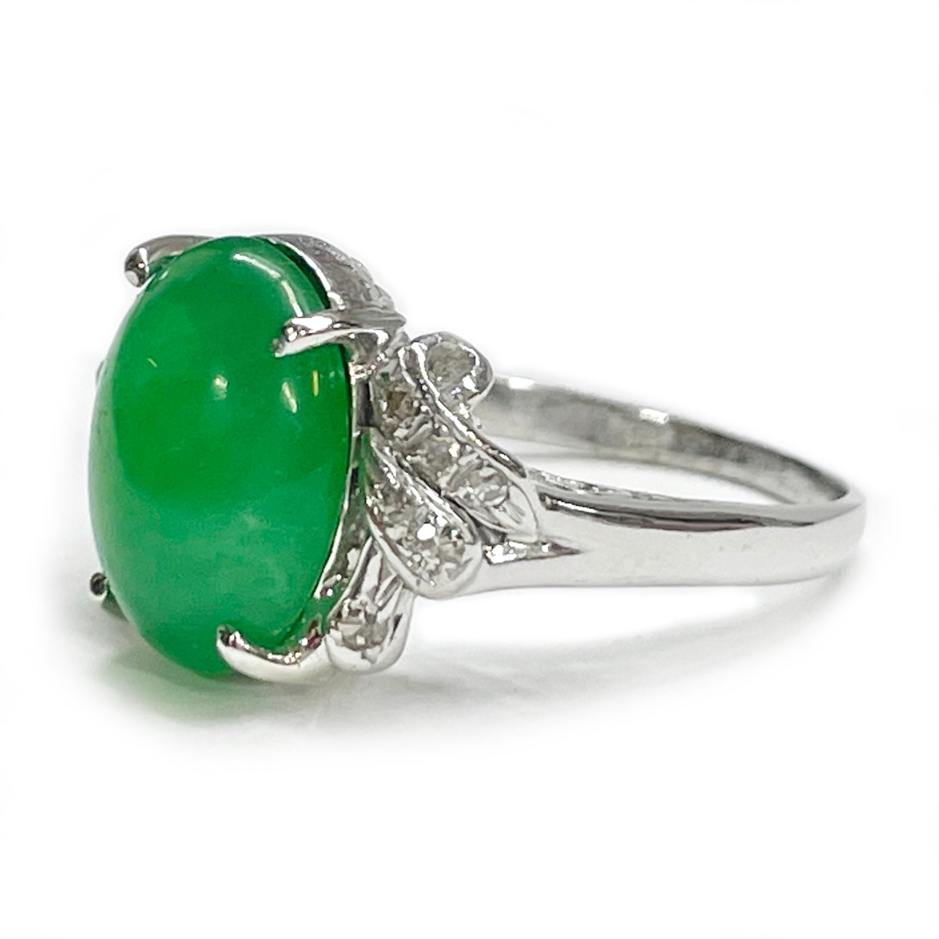 14 Karat White Gold Chrysoprase Diamond Ring. The ring features an green oval Chrysoprase cabochon four-prong set in the center of the ring and six small round melee diamonds on each side for a total of twelve diamonds. The stone has some light wear