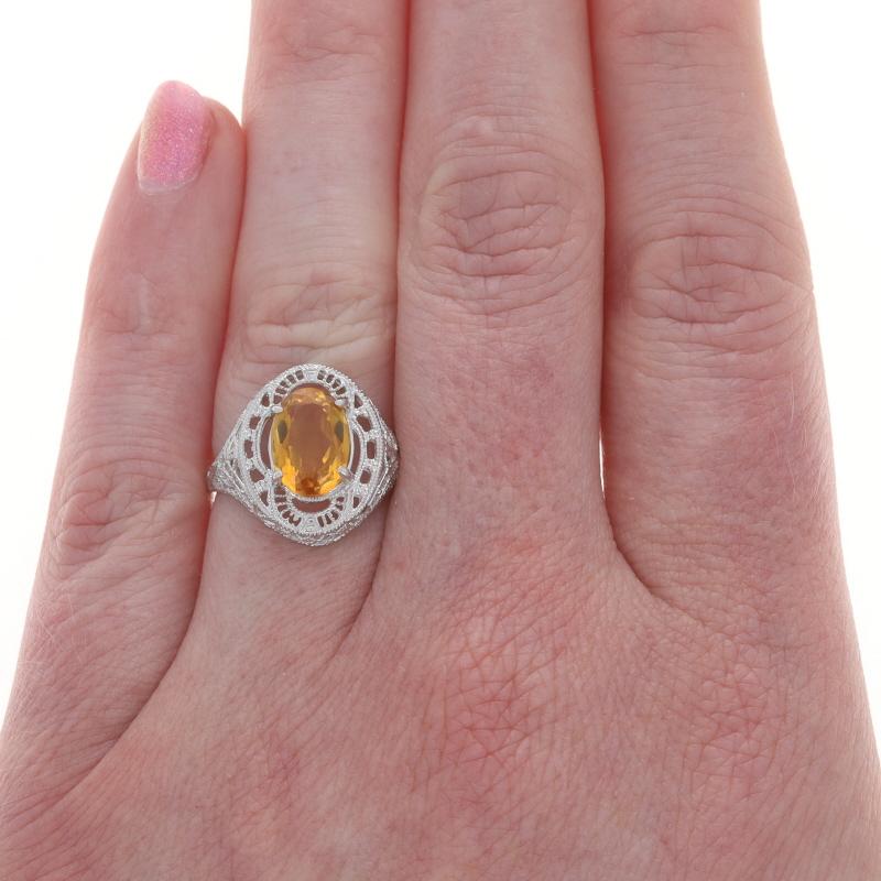 Size: 6 3/4
Sizing Fee: Up 1 size for $40 or Down 1 size for $40

Design:  Art Deco style

Metal Content: 10k White Gold

Stone Information

Natural Citrine
Treatment: Heating
Cut: Oval

Style: Cocktail Solitaire
Features: Milgrain & Filligree