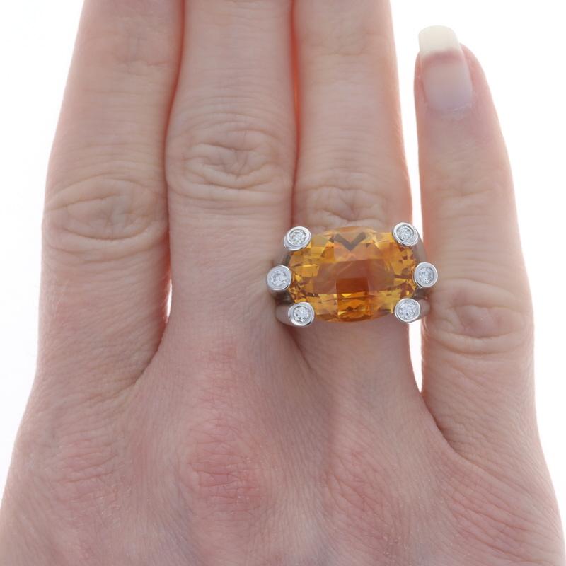 Size: 7 1/4

Metal Content: 18k White Gold

Stone Information

Natural Citrine
Treatment: Heating
Carat(s): 13.80ct
Cut: Oval Checkerboard
Color: Orange

Natural Diamonds
Carat(s): .30ctw
Cut: Round Brilliant
Color: G - H
Clarity: VS2 - SI1

Total