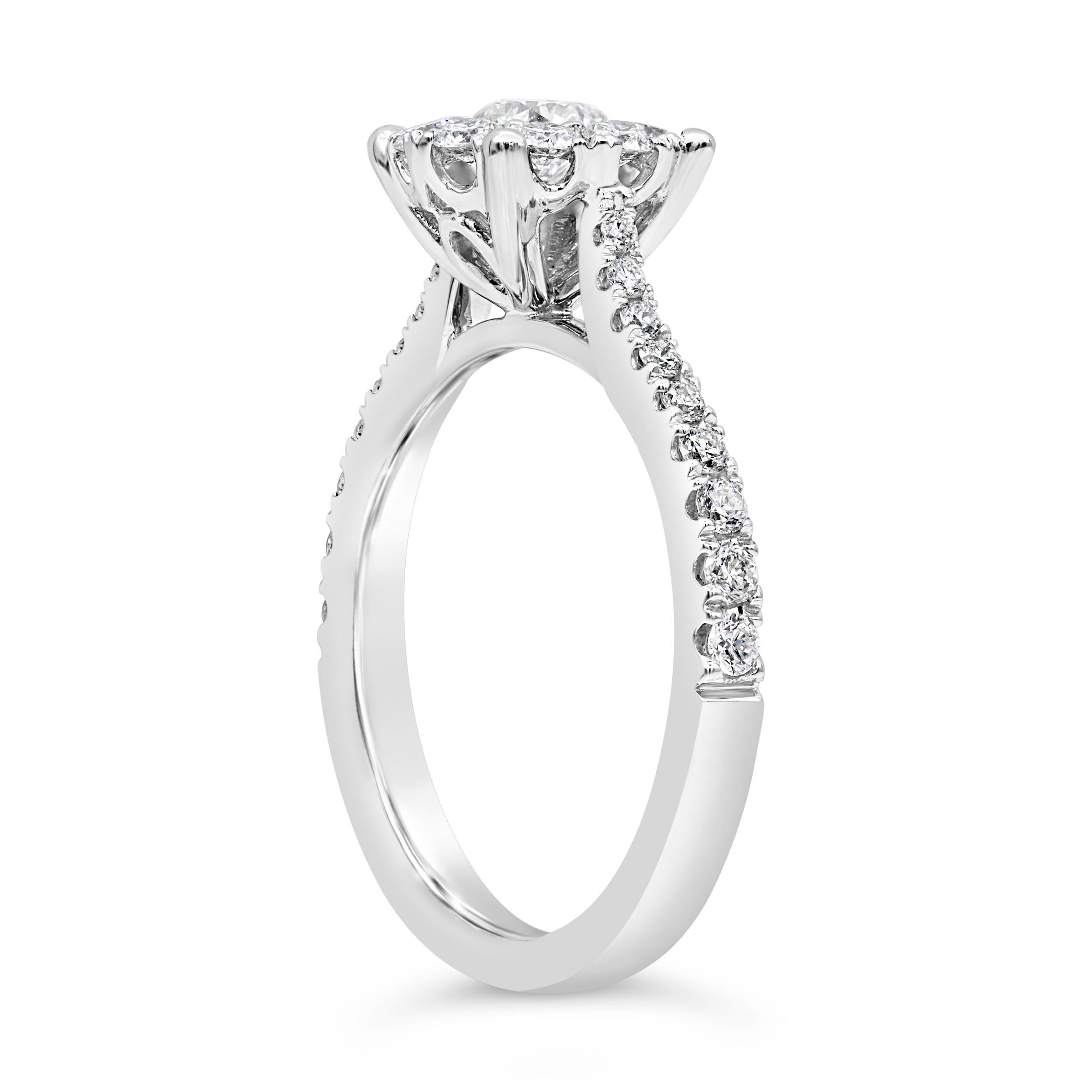A unique engagement ring style showcasing a cluster of round brilliant diamonds to make it look like one large center diamond! Set on an 18 karat white gold mounting accented with diamonds. Diamonds weigh 0.93 carats total. Size 6.5 US, resizable