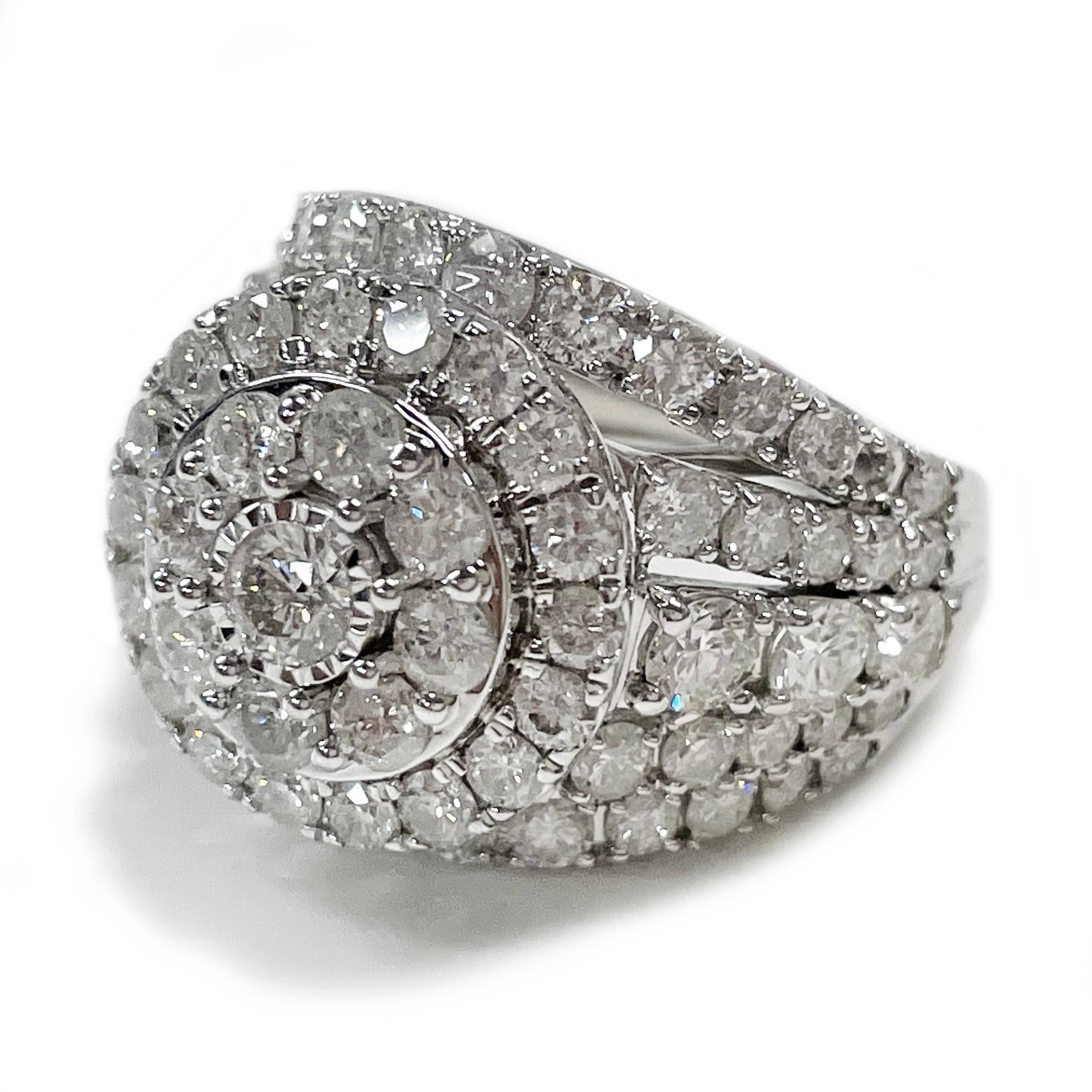 14 Karat White Gold Cluster Diamond Ring. Seventy-one sparkling round prong-set diamonds. The design consists of a center diamond with two circles of diamonds and a split band of five rows of diamonds set on half of the band. The diamonds measure