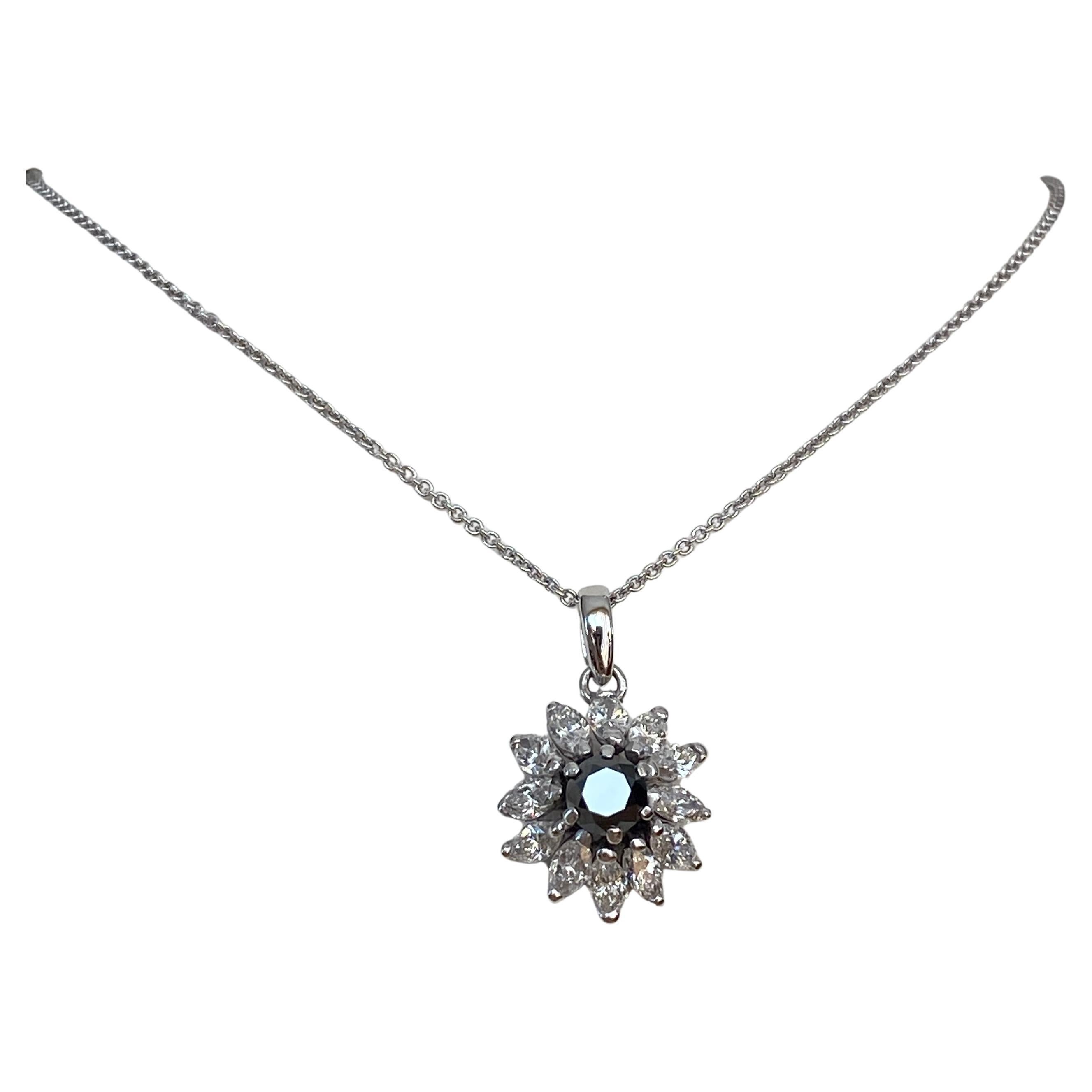 Offered in good condition, 18 kt white gold collier with 14 kt white gold  designer flower  pendant  in the middle of 1 piece of black diamond of approximately 1.00 crt, surrounded by 12 pieces of marquise cut diamonds of approximately 1.80 crt.