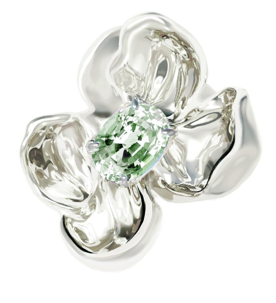 This Magnolia Flower contemporary engagement or cocktail ring is in 14 karat white gold with clear light green sapphire, oval cut. The water-surface of the gem multiplies the light, mirroring on the golden petals. The weight of the ring is 8.5 gr.