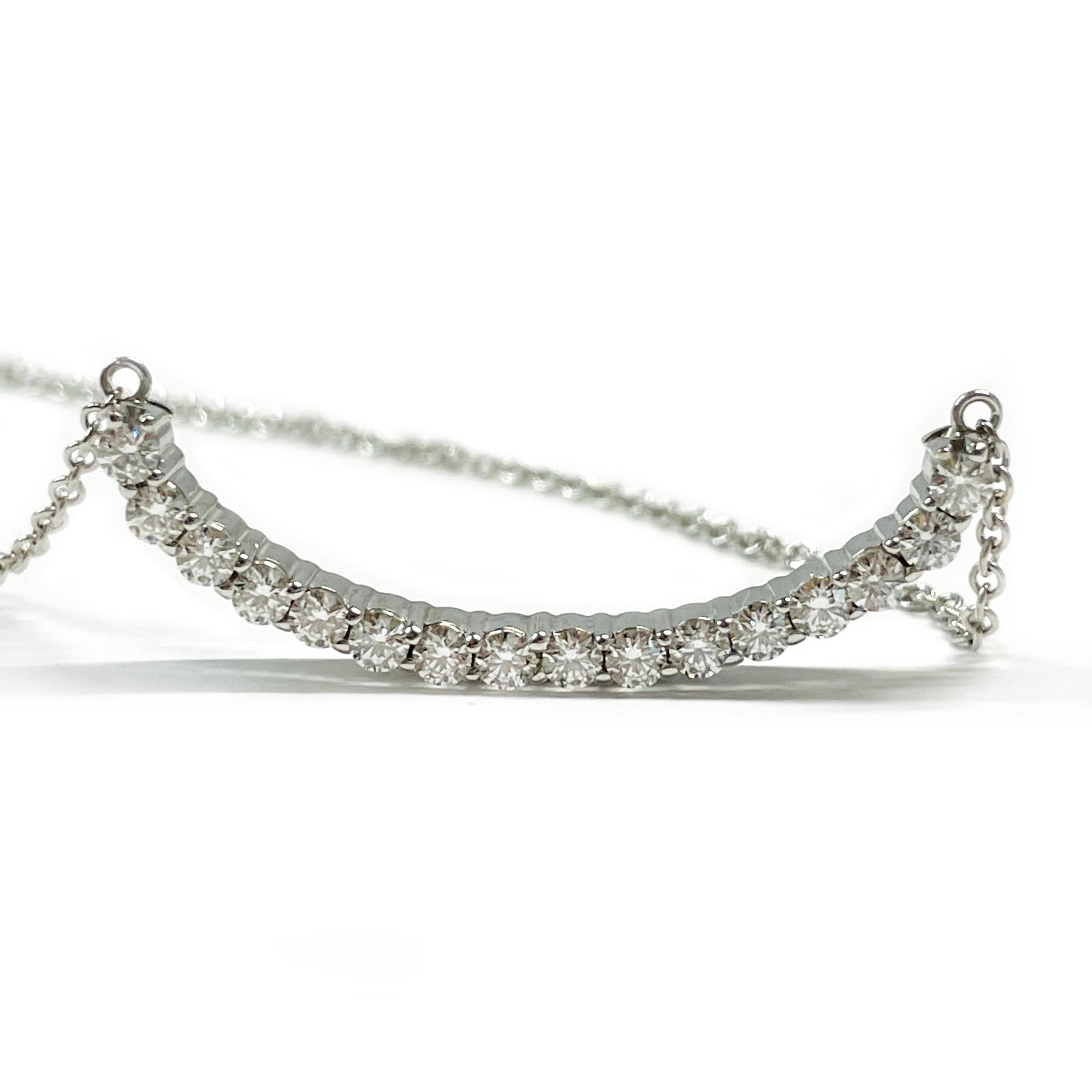 14 Karat White Gold Crescent Bar Diamond Necklace. Sixteen round diamonds are prong-set on a crescent-shaped bar with attached link chain. The diamonds measure 2.1mm for a carat total weight of 0.50ctw. The necklace has a lobster clasp and stamped
