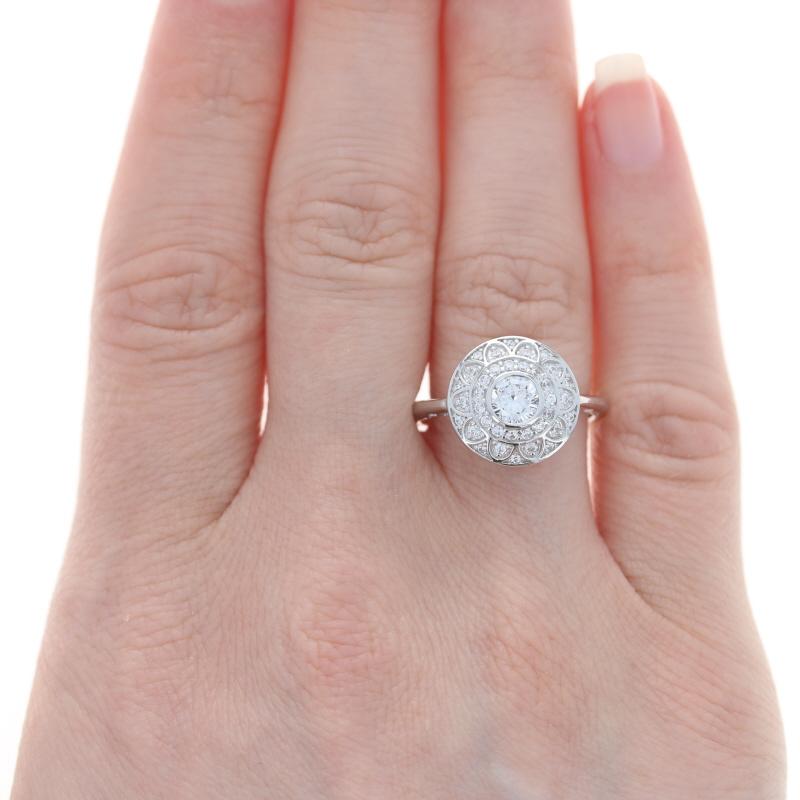 Size: 7 1/4
Sizing Fee: Down 2 for $30 or up 2 for $35

Metal Content: 14k White Gold

Stone Information
Cubic Zirconias
Total Carats: 1.00ctw dew
Cut: Round Brilliant
Color: Clear

Style: Triple Halo Solitaire with Accents 
Theme: