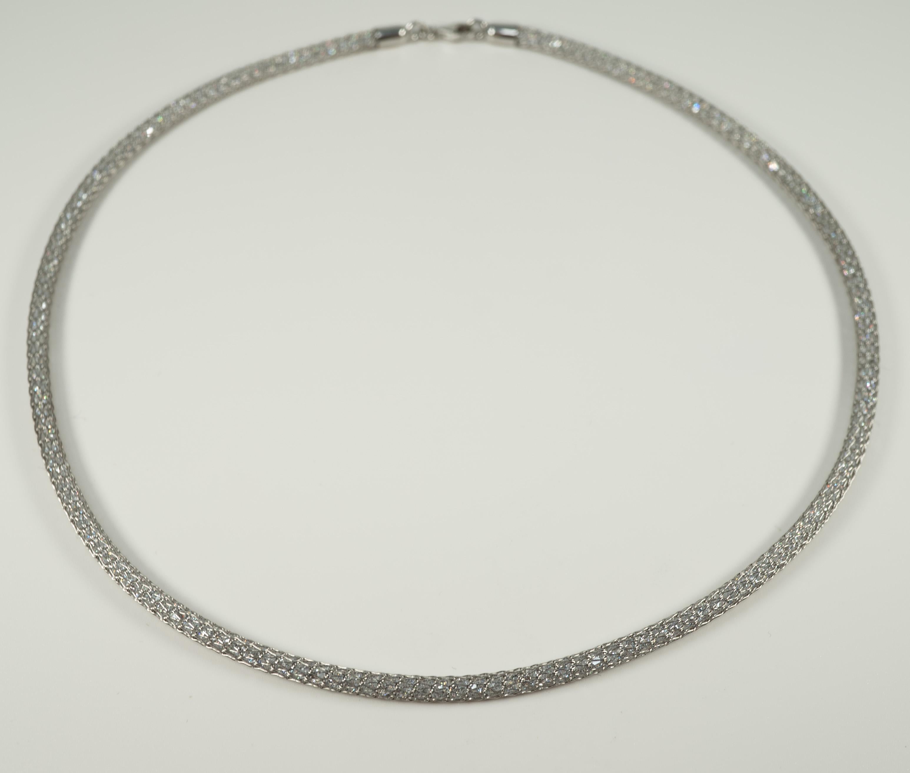 So interesting!  This 14 karat white gold, mesh necklace is filled with cubic zirconia stones and is secured with a lobster clasp. 
