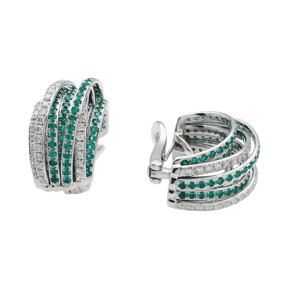 A 750/000 white gold De Grisogono pair of earrings, Allegra collection, each is made with nine interlaced rings, six of them are enhanced with emeralds and three with brilliant cut diamonds. 
Weight : 28,4 grams
Retail price: $45.000