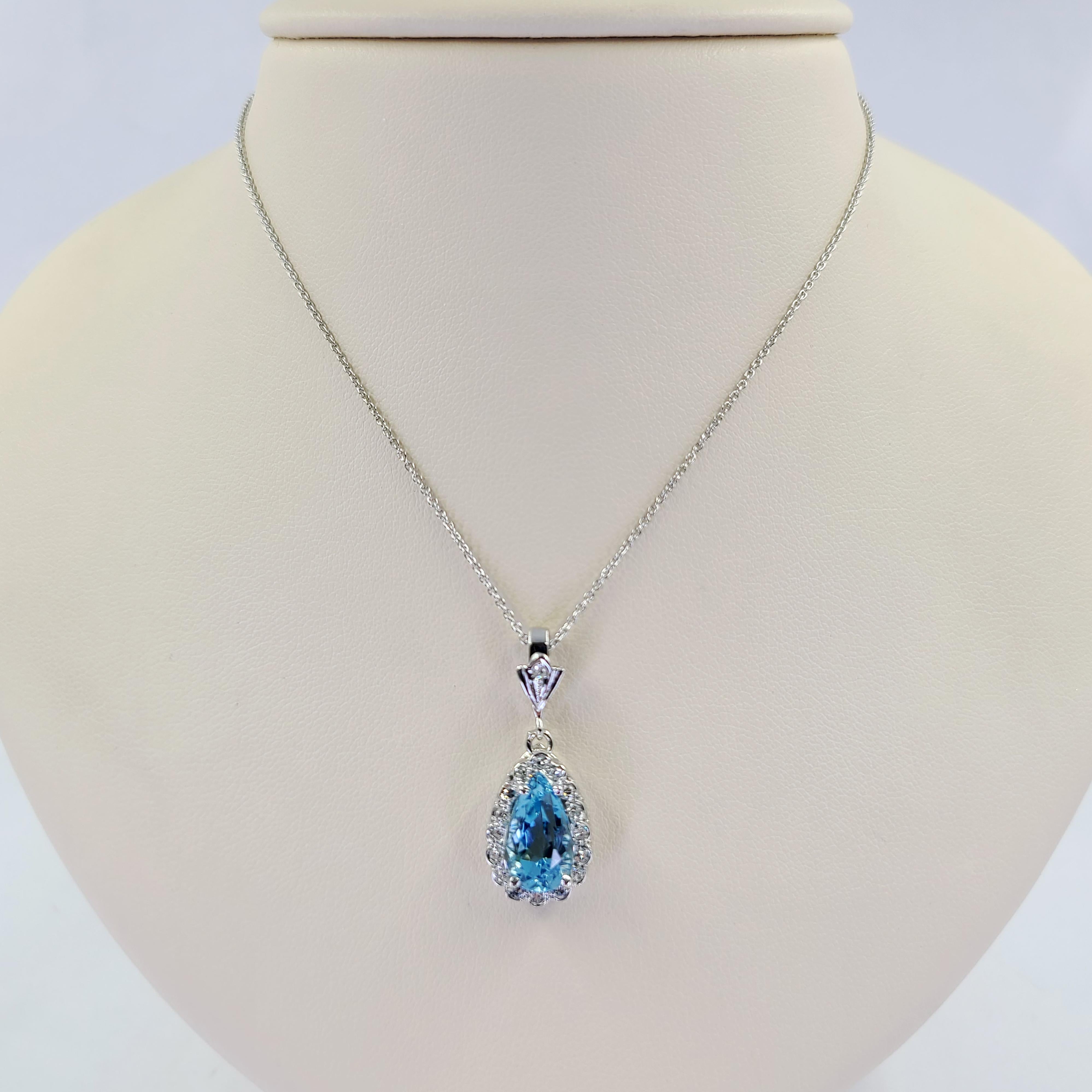 14 Karat White Gold Hinged Pendant Necklace Featuring A Pear Cut Aquamarine Estimated To Weigh 3.00 Carats Surrounded By 16 Single Cut Diamonds of VS Clarity and G/H Color Totaling 0.25 Carats. 16 Inch Rolo Chain with Lobster Clasp. Finished Weight