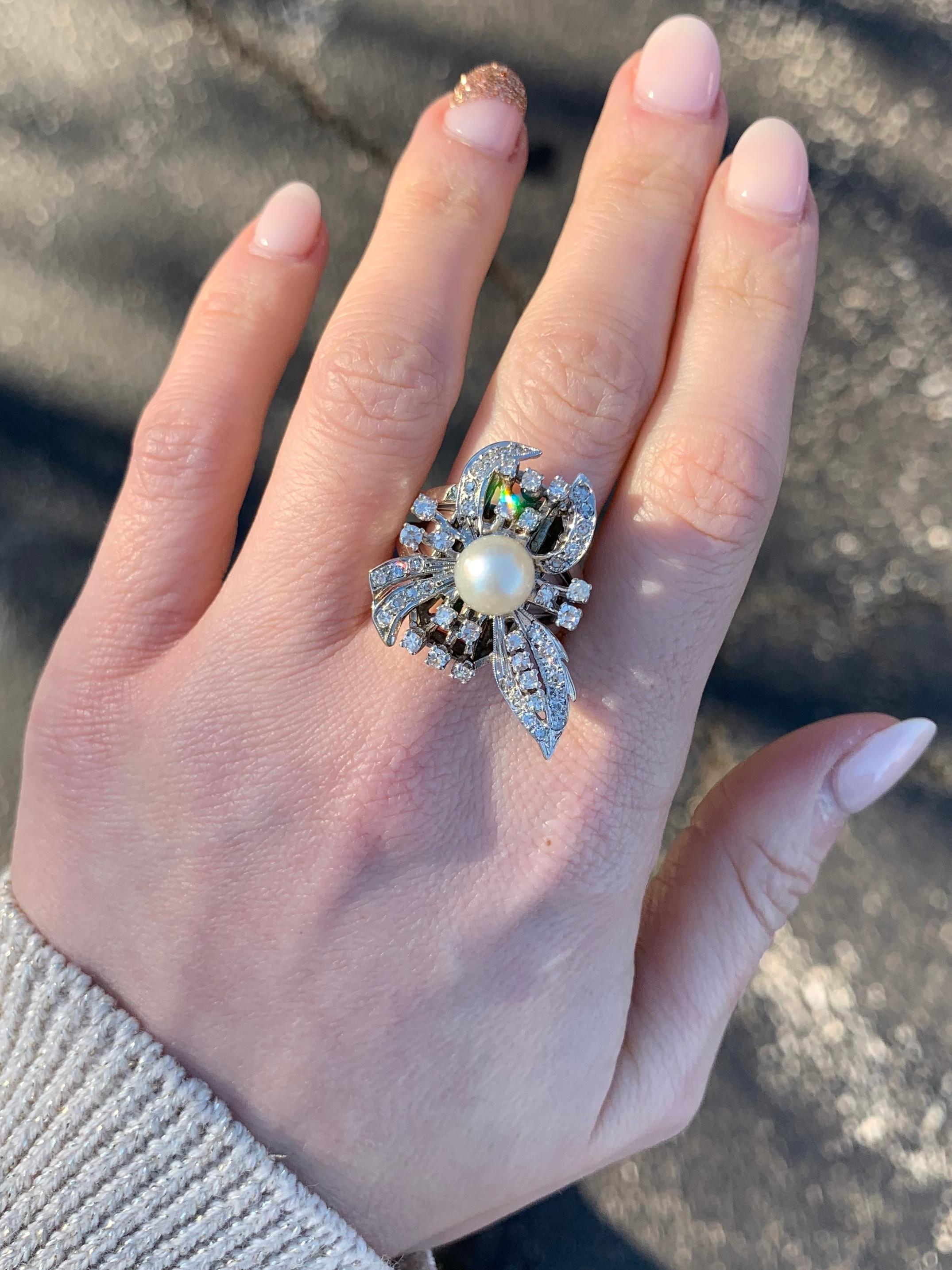 An elegant spray diamond ring, heavily influenced by the intricate and flowering designs of the Edwardian era. Ring features a 7.50mm white cultured pearl surrounded by 47 round diamonds at approximately 1.25 carats total weight, approximately H