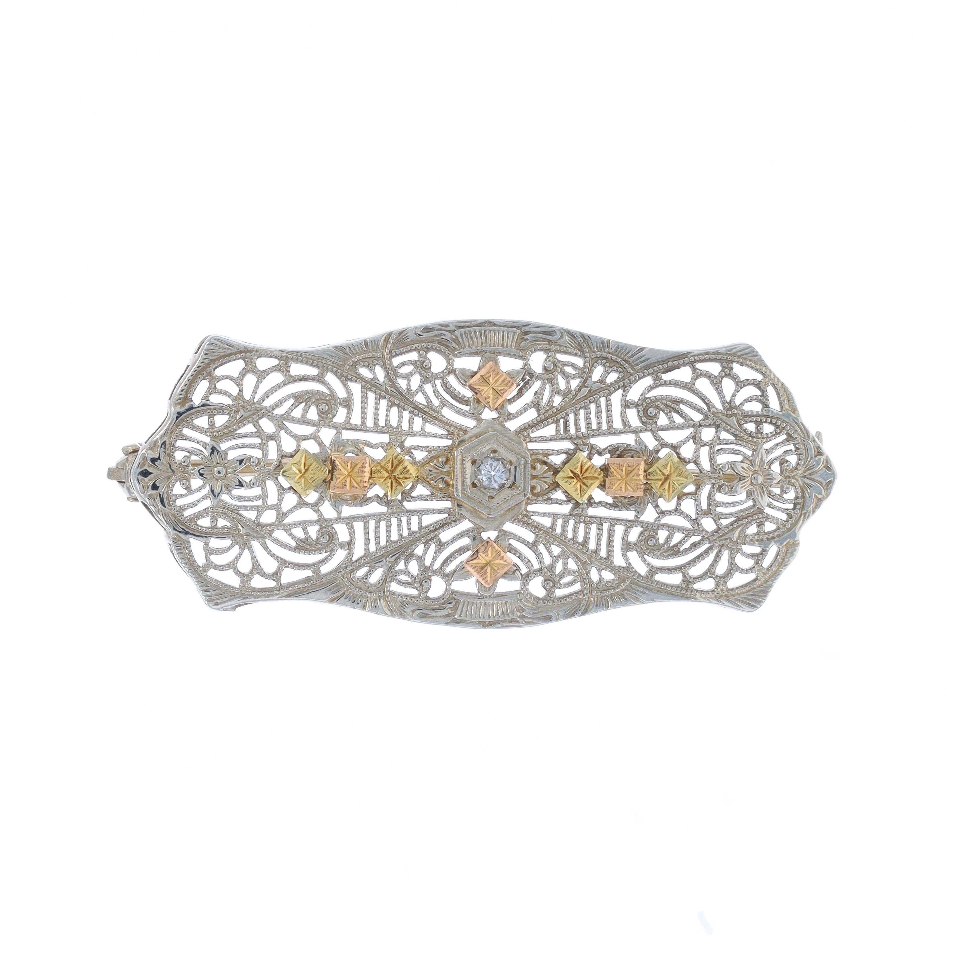 Era: Art Deco
Date: 1920s - 1930s

Metal Content: 10k White Gold, 10k Yellow Gold, & 10k Rose Gold

Stone Information

Natural Diamond
Carat(s): .04ct
Cut: Single
Color: G
Clarity: SI2

Style: Brooch
Fastening Type: Hinged Pin and Locking