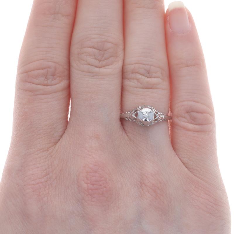 Size: 6
Sizing Fee: Up 2 sizes for $25 or Down 2 sizes for $25

Era: Art Deco
Date: 1920s - 1930s

Metal Content: 18k White Gold

Stone Information

Natural Diamond
Carat(s): .04ct
Cut: Single
Color: H
Clarity: I1

Style: Solitaire
Features: Floral