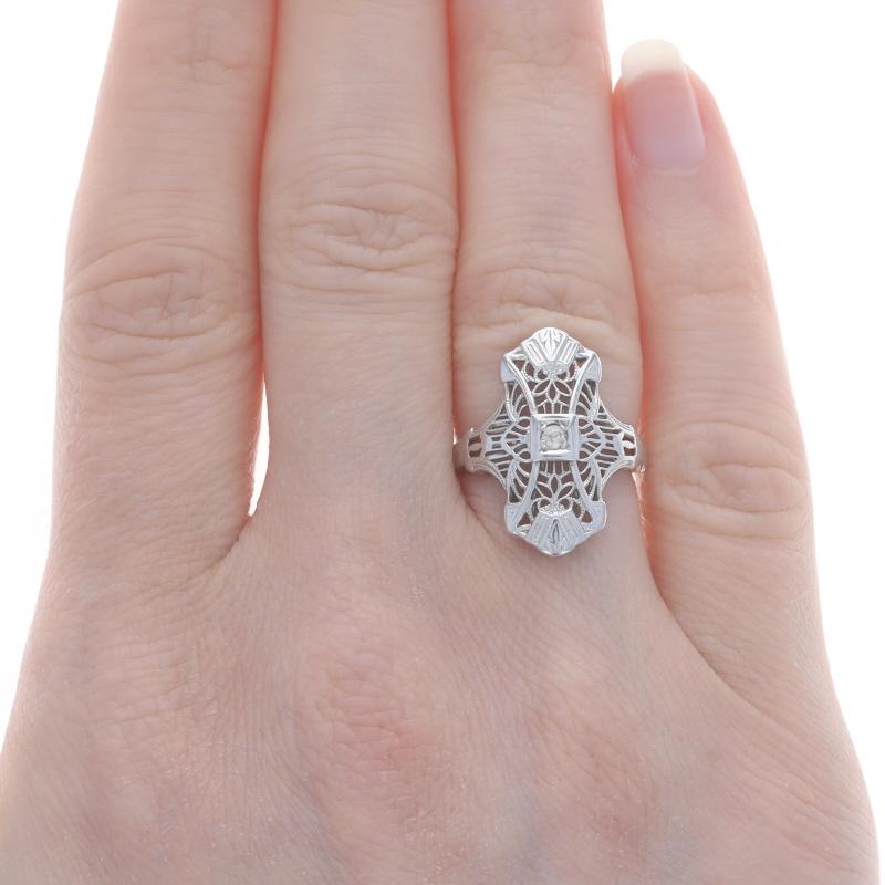 Size: 4 1/2
Sizing Fee: Up 1 1/2 sizes for $40 or Down 1 size for $40

Era: Art Deco
Date: 1920s - 1930s

Metal Content: 18k White Gold

Stone Information

Natural Diamond
Carat(s): .04ct
Cut: European
Color: I
Clarity: SI2

Style: Solitaire
Theme: