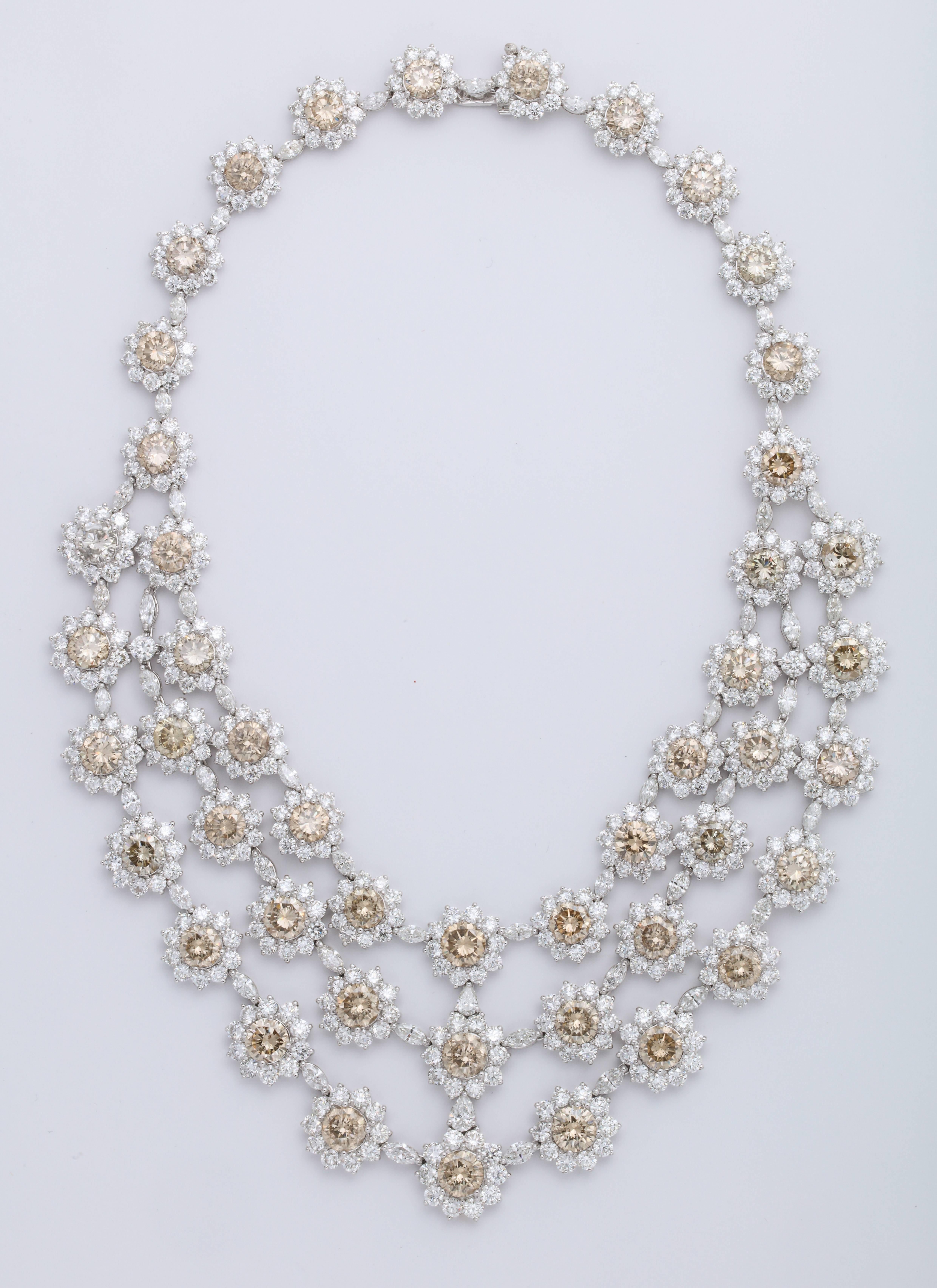 Crowning the Red Carpet is the Glamorous 18K white gold tapering triple strand necklace mounted with 47 calibrated natural color champagne, round brilliant-cut diamonds: 68.57 carats, each decorated with round brilliant-cut colorless diamond