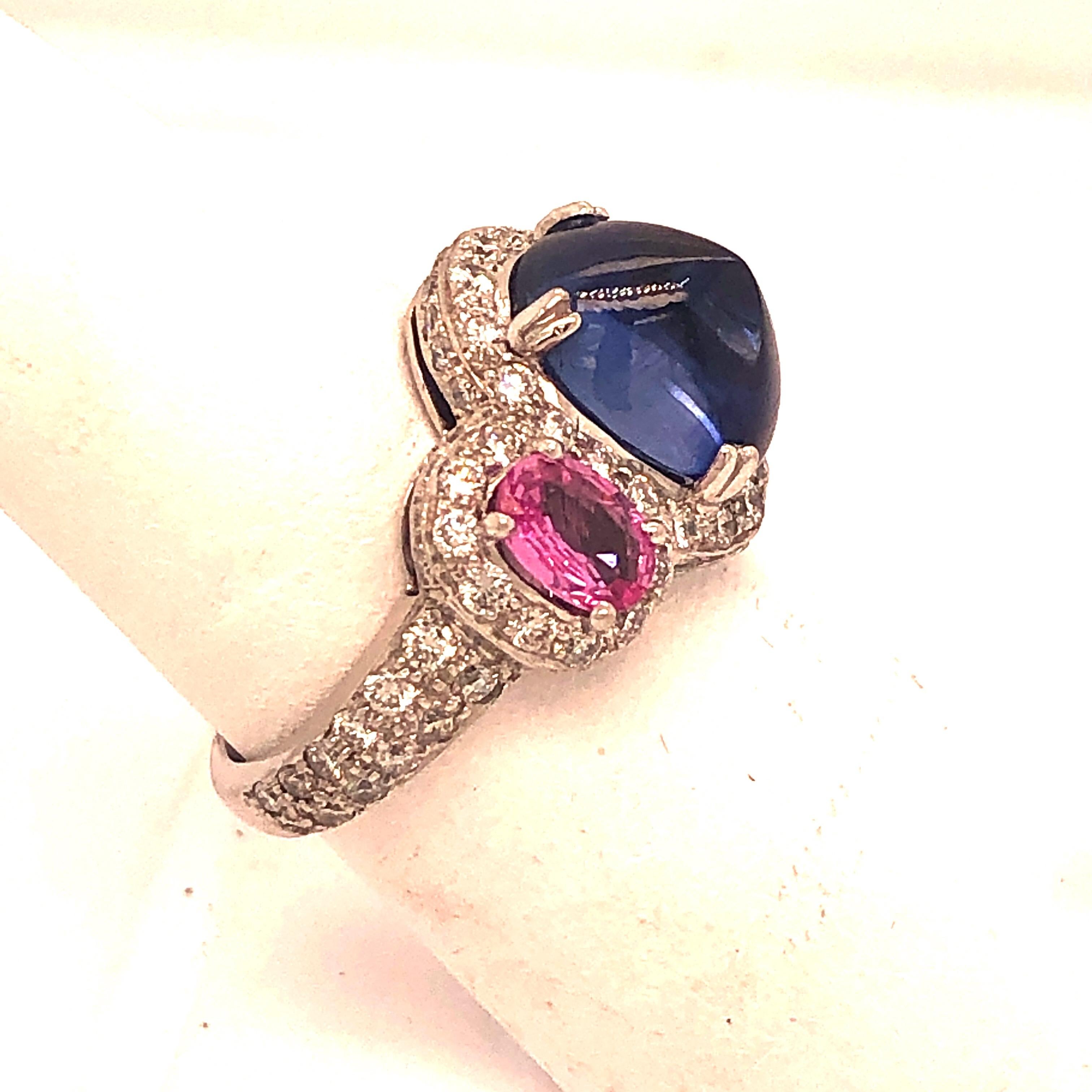 White Gold with 5 Carat Sugarloaf Sapphire  with 2 Pink Sapphires surrounded by Diamonds.  Size 5.5.  