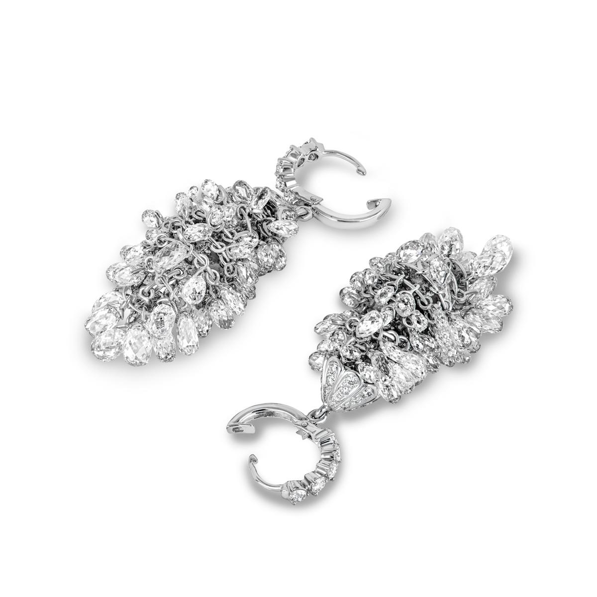 A fabulous pair of white gold diamond chandelier earrings. The earrings consist of a small hoop and connector each set with round brilliant cut diamonds, suspending an 8 tiered pattern of freely moving briolette cut diamonds. The round brilliant cut