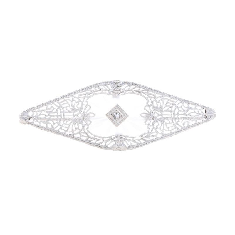 Era: Vintage

Metal Content: 10k White Gold

Stone Information
Natural Diamond
Carat: .02ct
Cut: Single
Color: H
Clarity: IS2

Material Information
Camphor Glass

Style: Brooch
Fastening Type: Hinged Pin and Locking C-Clasp
Features: Floral Filigree