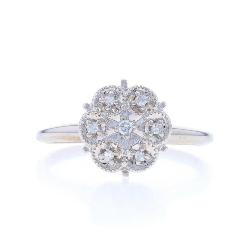 Size: 5 3/4
Sizing Fee: Up 3 sizes for $35 or Down 2 sizes for $35

Metal Content: 10k White Gold

Stone Information

Natural Diamonds
Carat(s): .06ctw
Cut: Round Brilliant (center) & Single
Color: G - H
Clarity: SI1 - SI2

Style: Cluster
Theme: