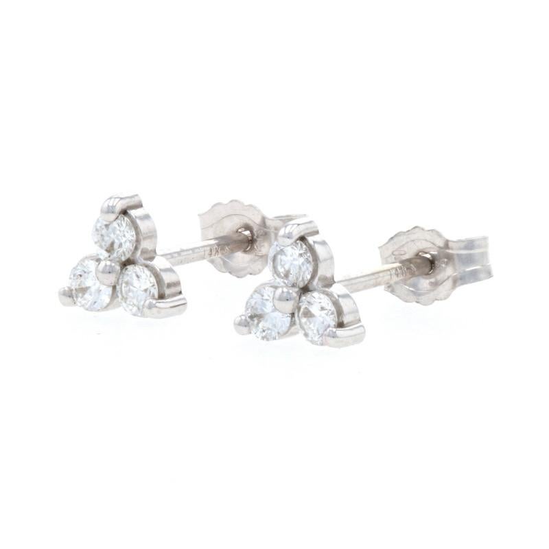 Metal Content: 14k White Gold 

Stone Information: 
Natural Diamonds
Total Carats: .20ctw 
Cut: Round Brilliant 
Color: F - G 
Clarity: VS2 - SI1 

Style: Cluster Stud 
Fastening Type: Butterfly Closures 
Theme: Floral Leaf-Inspired 

Measurements:
