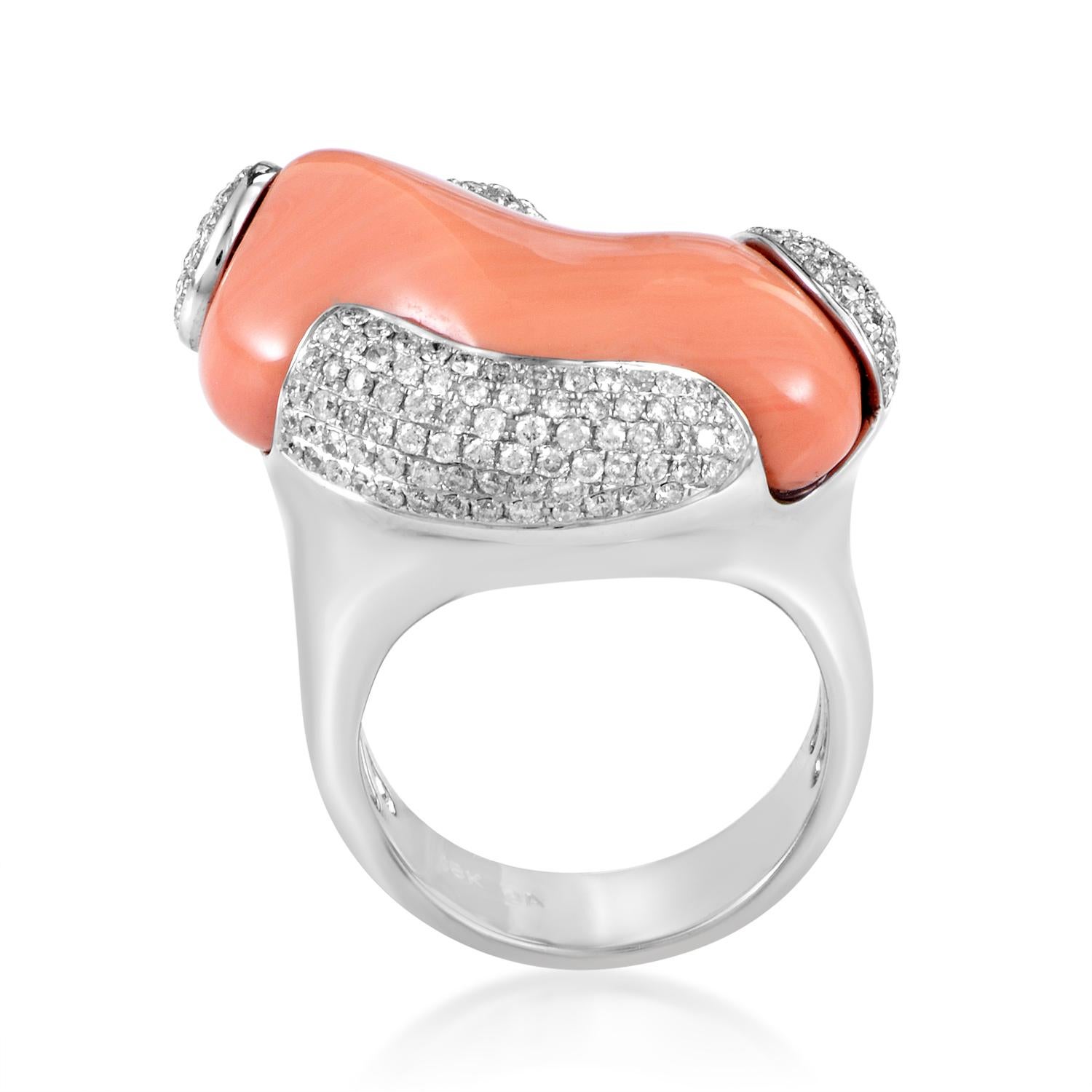 Producing excellent contrast through combining the warm tone and smooth surface of marvelous coral stone with cool glisten and scintillating play of light of the diamonds totaling 1.04 carats, this is a well-balanced 18K white gold ring.<br />Ring