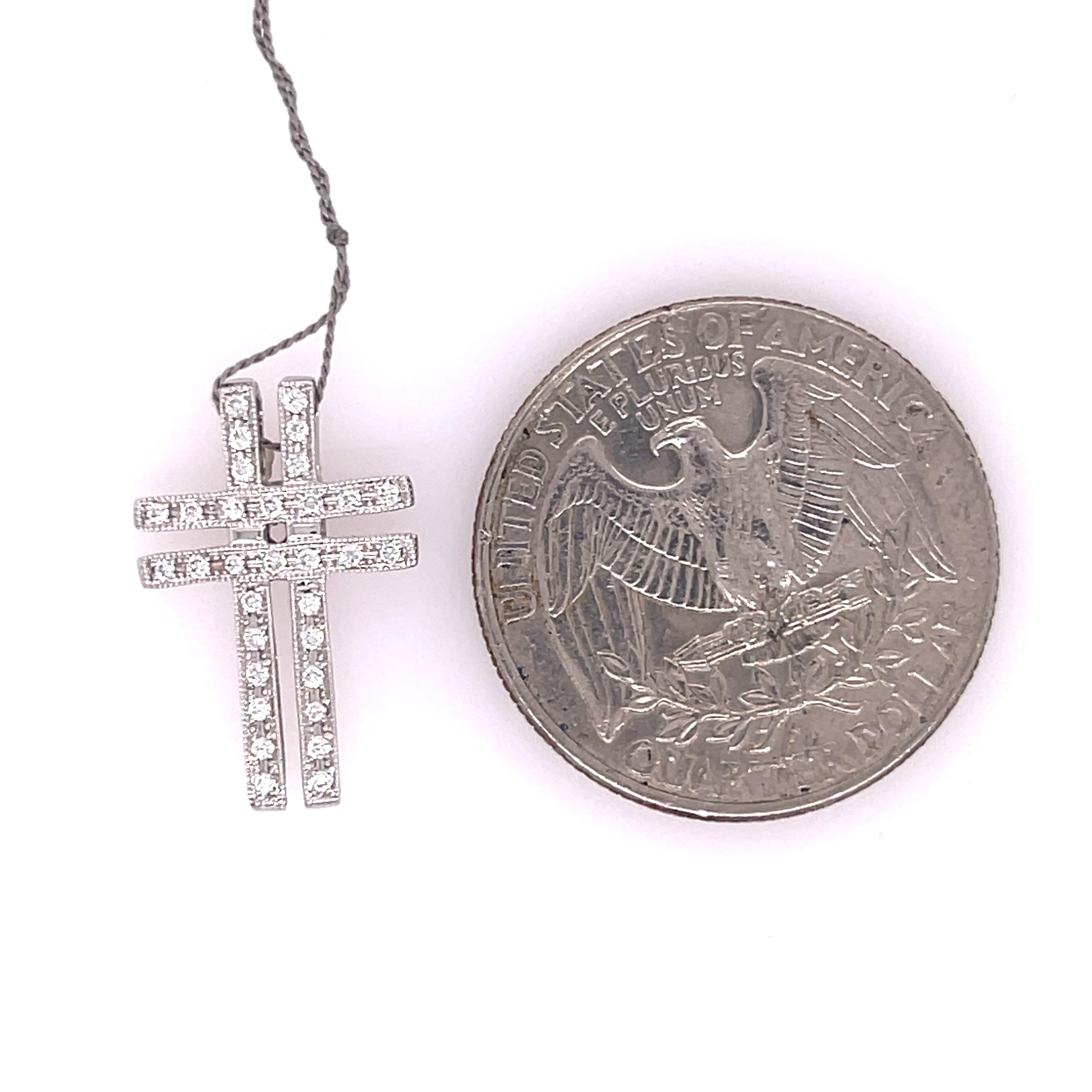 Diamond cross pendant in 18K white gold. The cross features 0.16ctw of diamonds. 