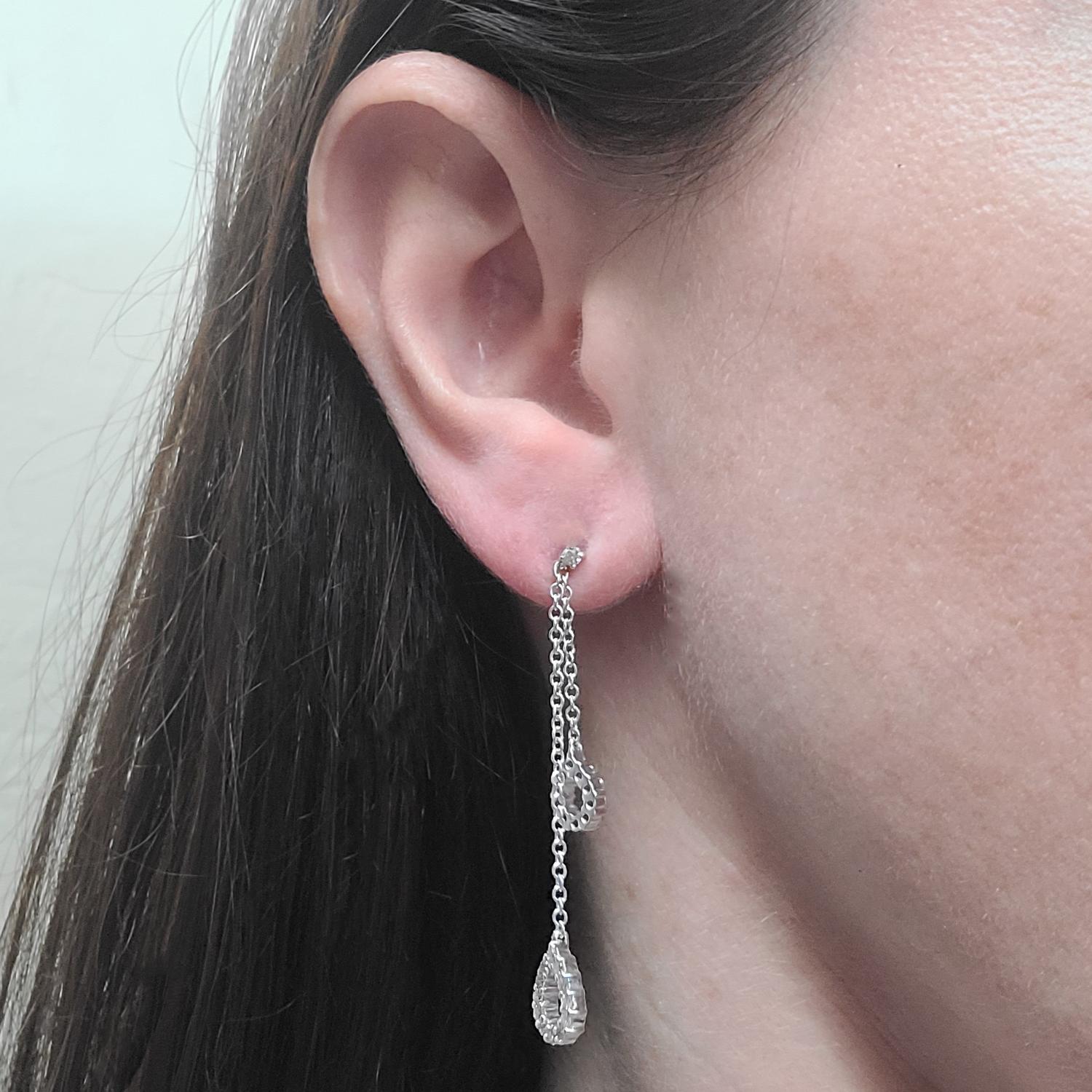 14 Karat White Gold Pear Drop Earrings Featuring 46 Round Brilliant Cut Diamonds Of I1 Clarity & H Color Totaling Approximately 1.00 Carat. 2.1 Inches Long. Finished Weight Is 3.9 Grams.