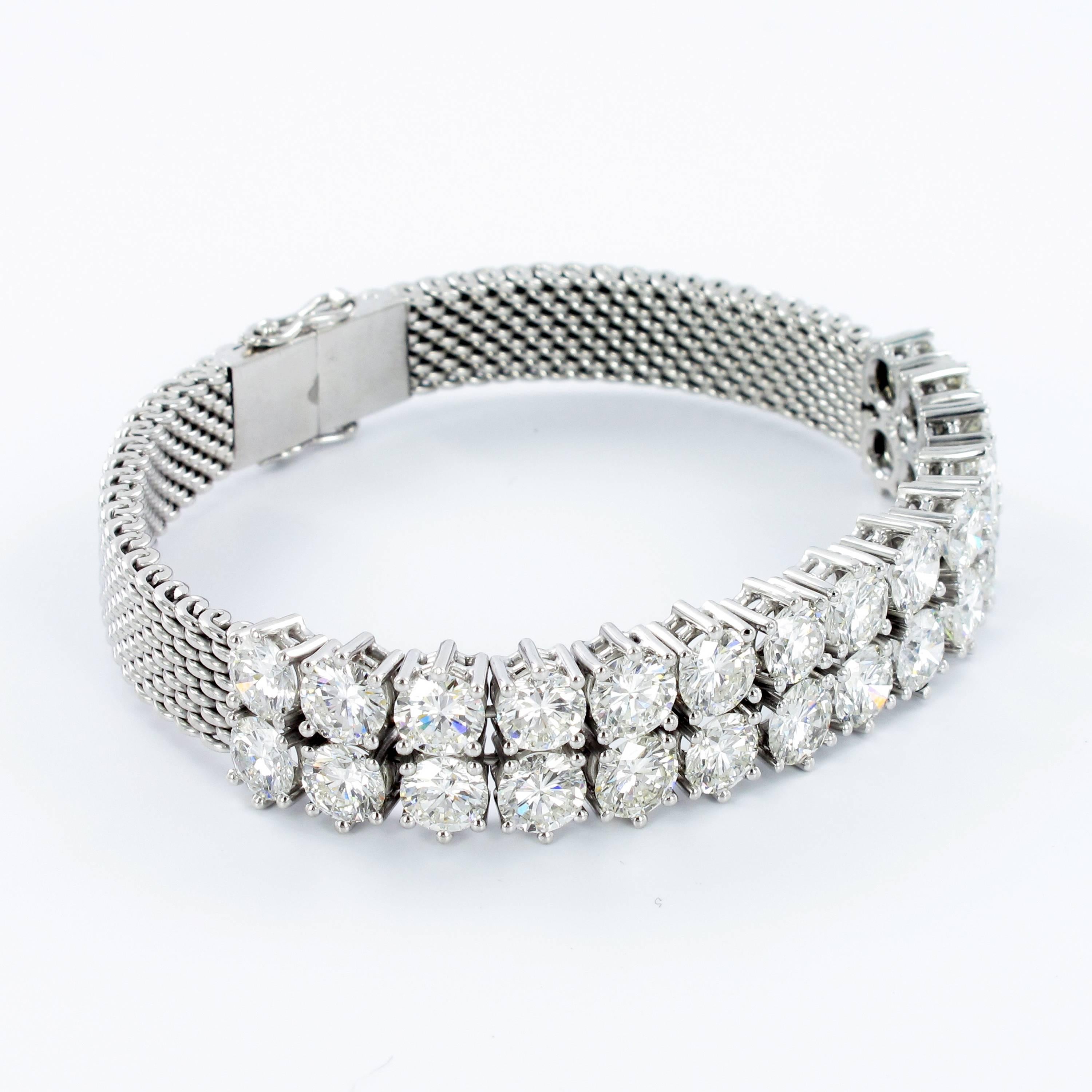 Double row diamond bracelet manufactured in white gold 750. Prong set with 28 brilliant round cut diamonds totaling approximate 12.45 ct. Fine make and quality (F/G-vs). Clean, bold design. Box clasp with two safety hooks. The bracelet is in perfect