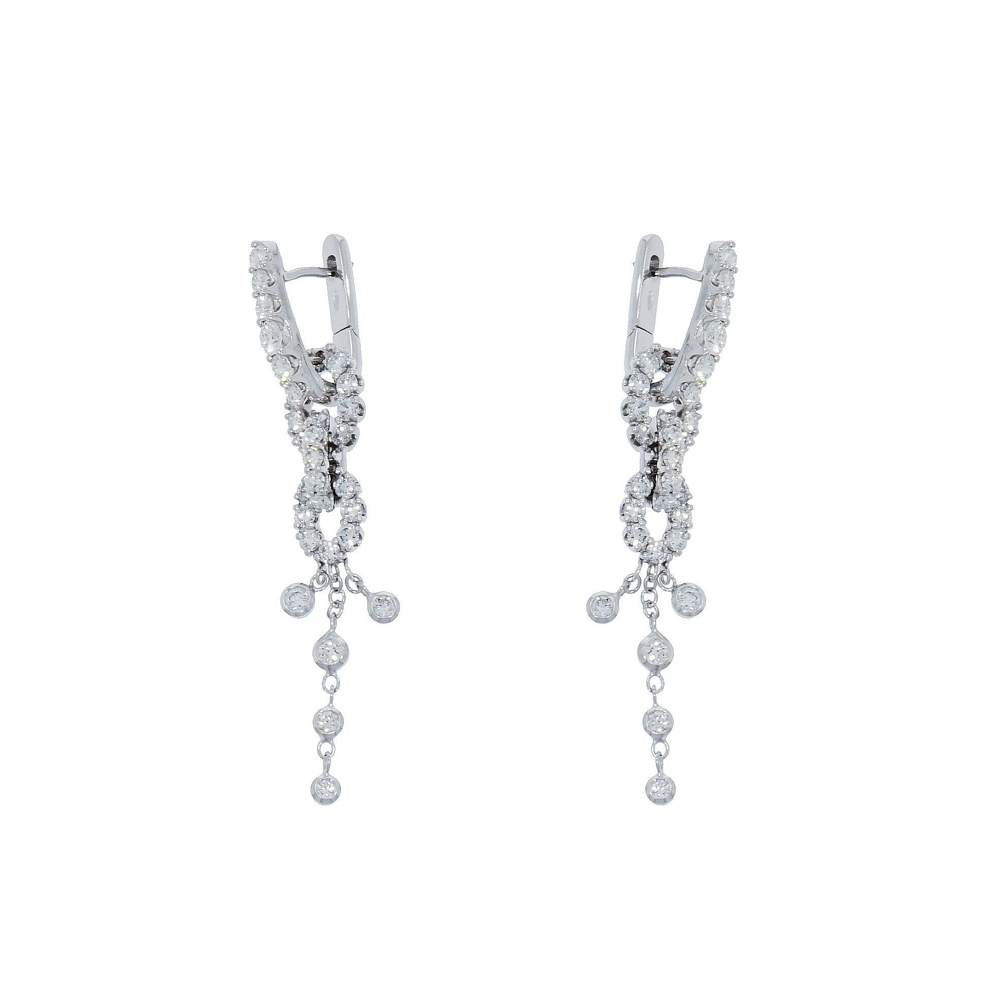 Designed with sophisticated details, the combination of prong and bezel set Diamonds creates a contrast where light and sparkles becomes the protagonist.
This precious and feminine Diamond Drop Earrings are crafted in Italy, in 18k White Gold and 62