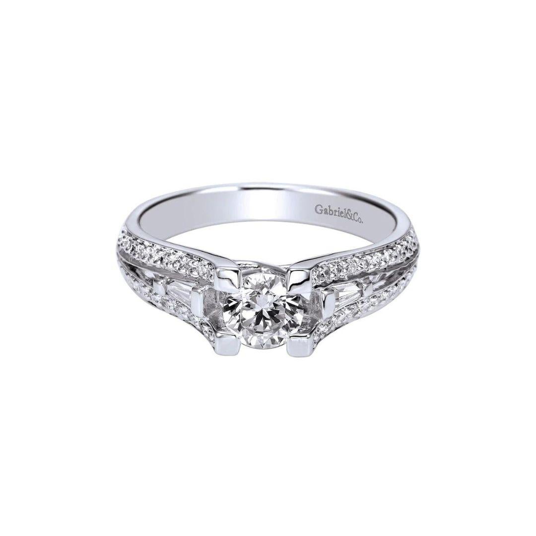 Ladies' Diamond Halo Engagement Ring in 14k White Gold.﻿ Center diamond weighs 0.45ct, H color, SI2 clarity, round brilliant cut. Side diamonds are 0.40ctw, H color, SI1 clarity.