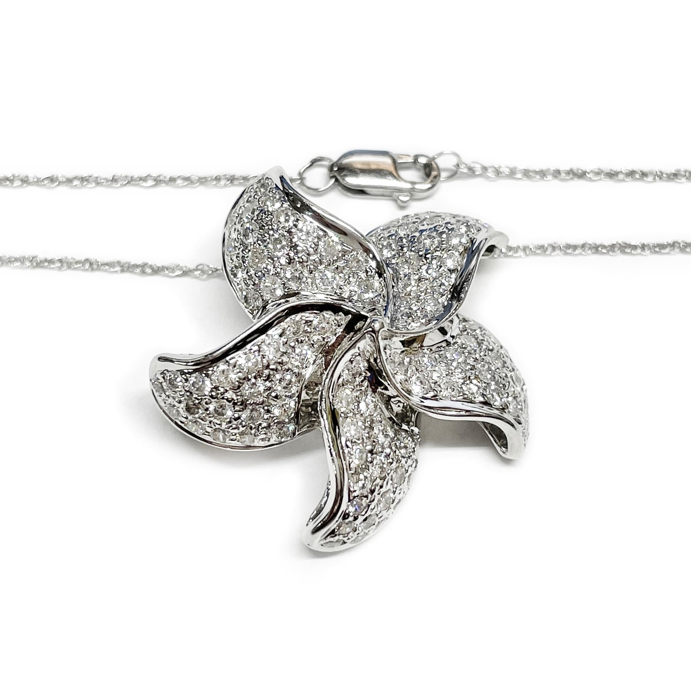 18 Karat White Gold Diamond Flower Pendant/Brooch Necklace. The pendant features a five-pedal flower with eighty 1.7mm round pave-set brilliant-cut diamonds. The pendant can also be worn as a brooch/pin. The diamonds are VS1 (G.I.A.) in clarity and