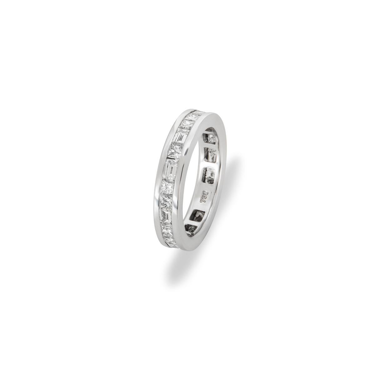 An 18k white gold diamond full eternity ring. The ring comprises of 18 princess cut and 9 baguette cut diamonds in a full eternity channel setting. The princess cut diamonds have an approximate weight of 1.80ct and the baguette cut diamonds have an
