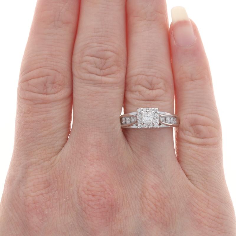 Size: 7
Sizing Fee: Up 1 size for $40 or Down 1/2 a size for $40

Metal Content: 14k White Gold

Stone Information

Natural Diamond
Carat(s): .20ct
Cut: Princess
Color: G
Clarity: SI1

Natural Diamonds
Carat(s): .50ctw
Cut: Round Brilliant
Color: H