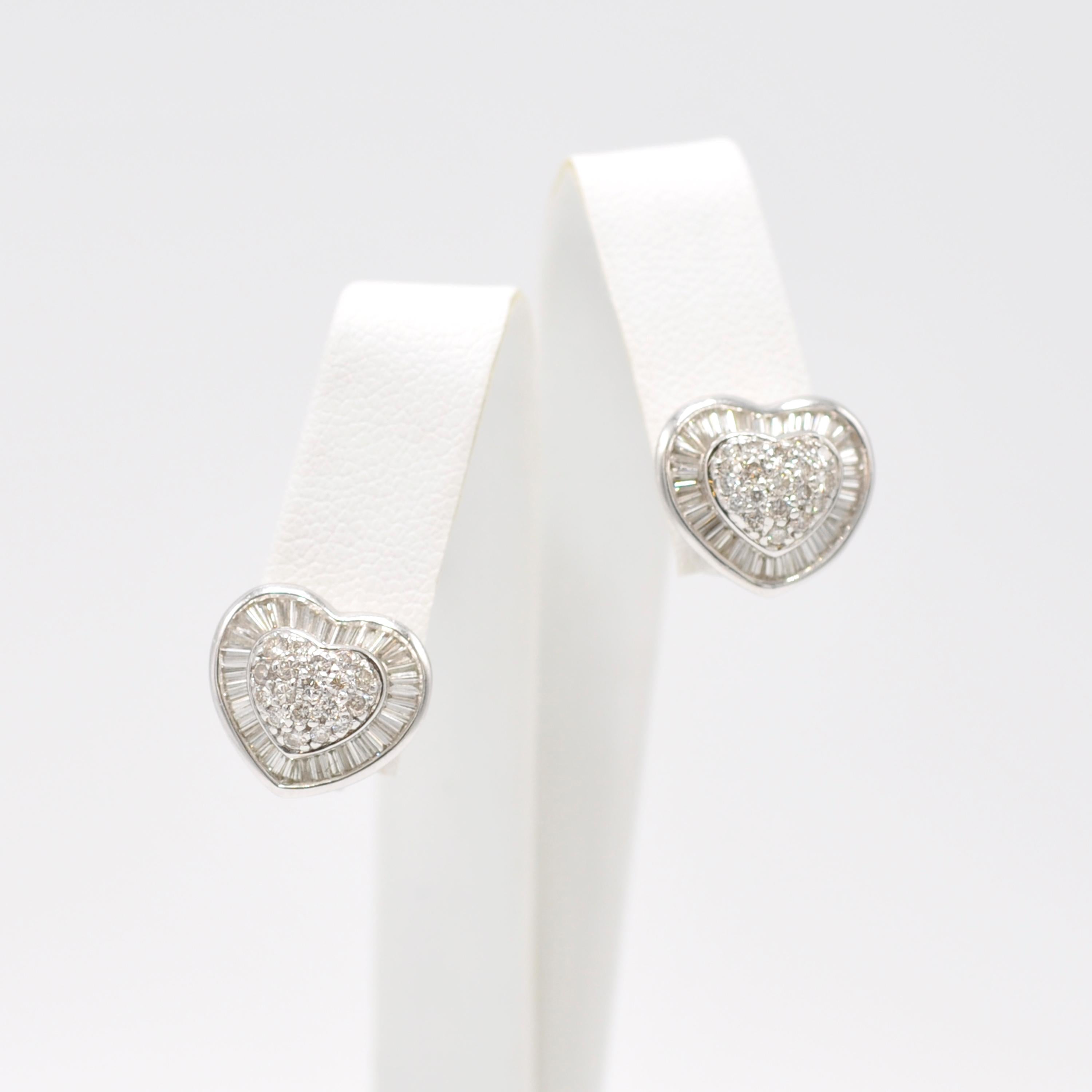 These brilliant 18 Karat white gold diamond heart earring studs are perfect for a subtle statement. Round diamonds surrounded by baguette diamonds in a heart shape make a lovely gift for your loved one. 

Stamped 'K18 and D188'