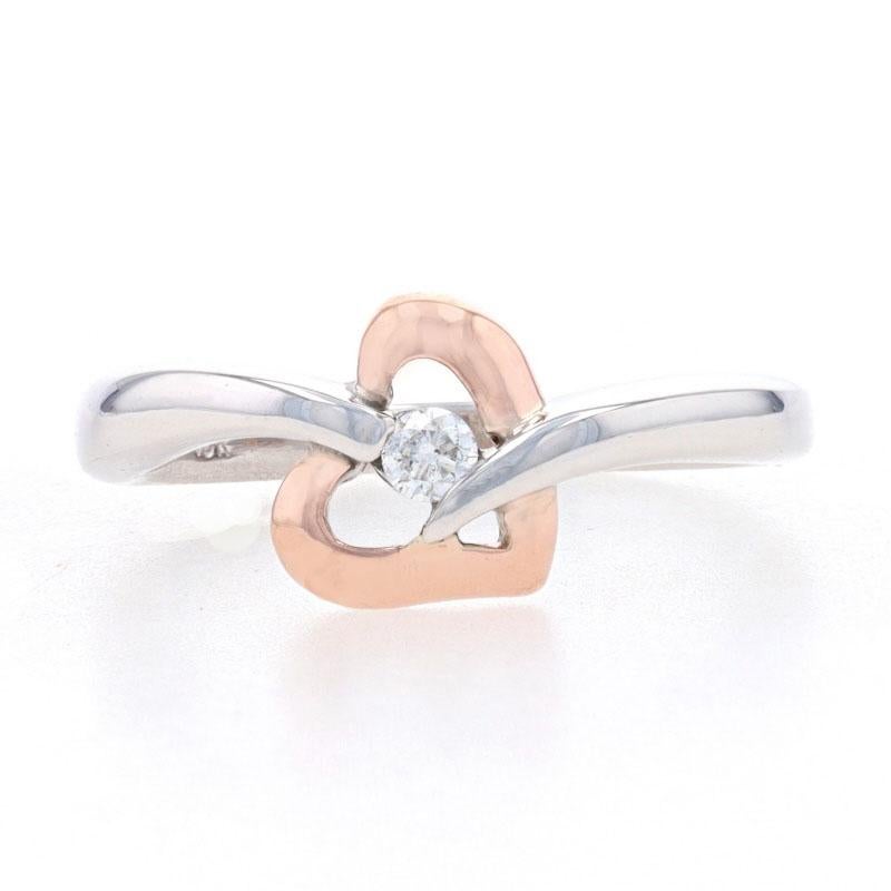 Size: 5
Sizing Fee: Down 1 for $30 or up 2 for $35

Metal Content: 10k White Gold & 10k Rose Gold

Stone Information

Natural Diamond
Carat(s): .05ct
Cut: Round Brilliant
Color: G
Clarity: SI2

Style: Solitaire Bypass 
Theme: Heart