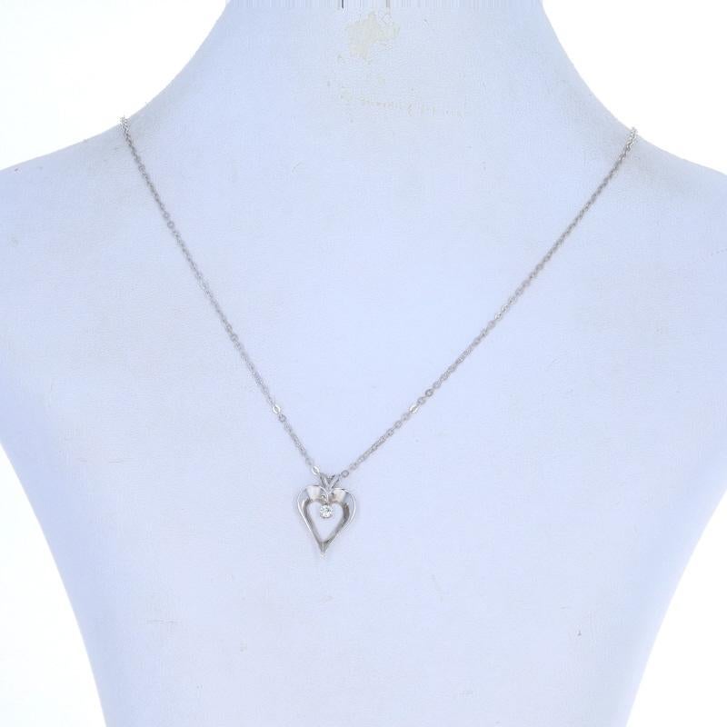 Metal Content: 14k White Gold

Stone Information

Natural Diamond
Carat(s): .08ct
Cut: Round Brilliant
Color: G
Clarity: VS1

Style: Solitaire
Chain Style: Flat Cable
Necklace Style: Chain
Fastening Type: Lobster Claw Clasp
Theme: Heart,