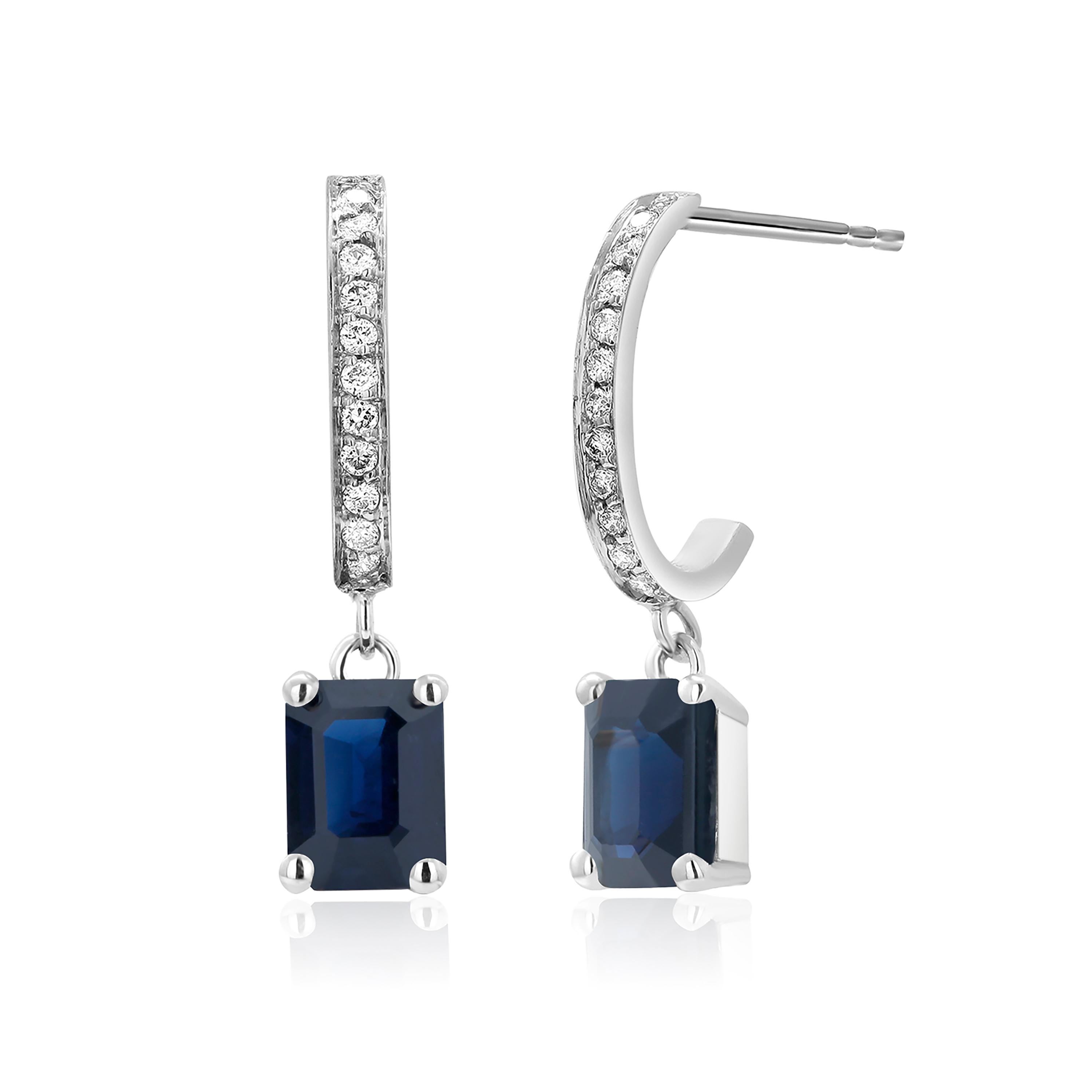 Fourteen karats white gold drop hoop earrings 
Round diamonds weighing 0.25 carats 
Two matched emerald-shaped blue sapphires weighing 2.00 carat
Sapphires are of royal blue hue
New Earrings
Handmade in the USA
The 14 karat gold earrings are hanging