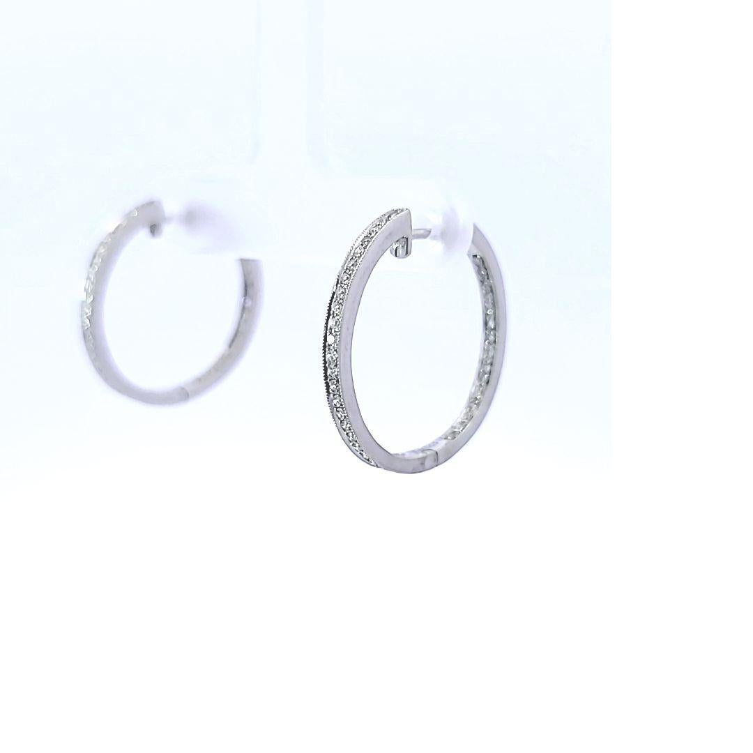 This lovely pair of 14 karat white gold, in and out earrings has an estimated total weight of 0.25 carats of diamonds. 