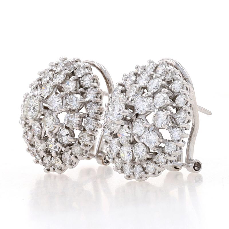 Metal Content: 18k White Gold

Stone Information
Natural Diamonds
Carat(s): 4.75ctw
Cut: Round Brilliant
Color: E - F
Clarity: SI1 - SI2

Total Carats: 4.75ctw

Style: Large Cluster Halo Stud
Fastening Type: Omega Closures
Features: Tiered