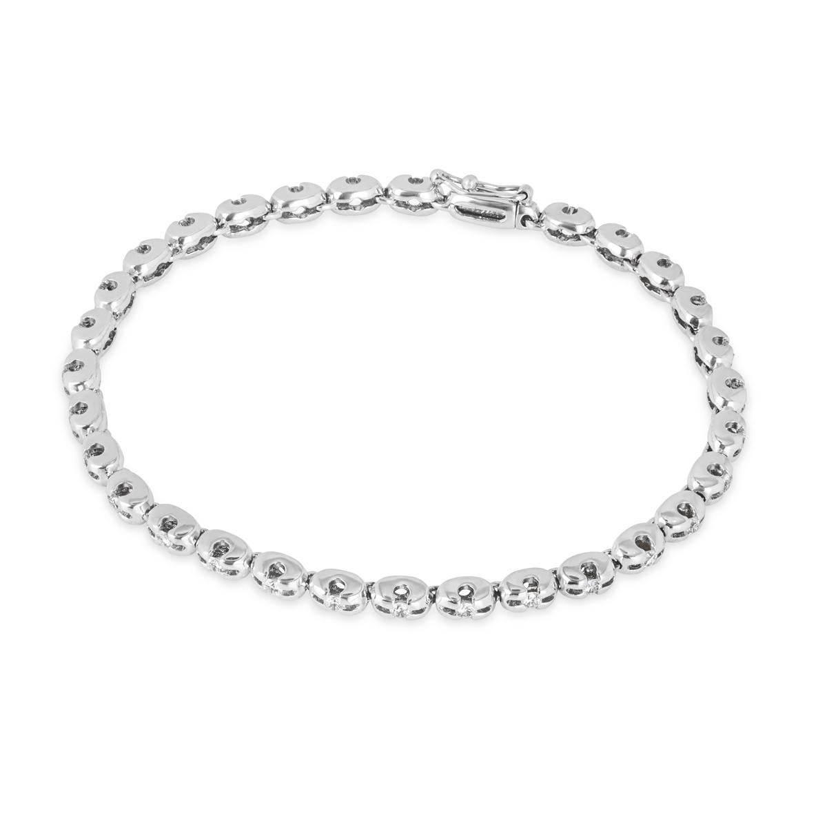 A beautiful 18k white gold diamond line bracelet. The bracelet features 30 round brilliant cut diamonds tension set in an openwork link setting with an approximate weight of 0.90ct, F-H colour and VS clarity. The 7-inch link bracelet finishes with a
