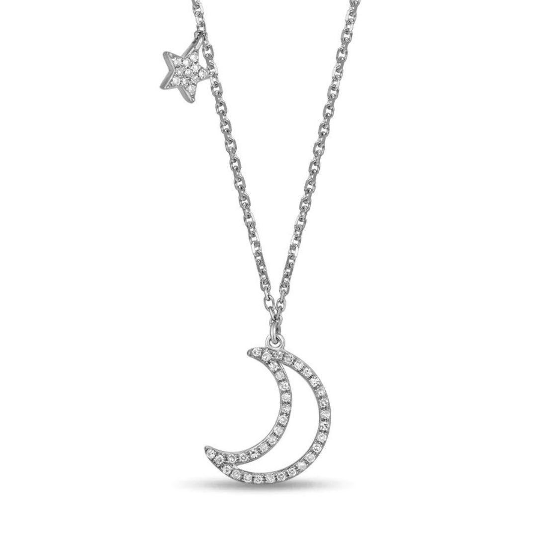 Fashionable moon and star drop pendant in 14k white gold. Wear on its own or layer it with other necklaces. Pendant contains forty seven round white diamonds, H-I color, SI clarity, 0.15 ctw. Adjustable length 16-18 inches