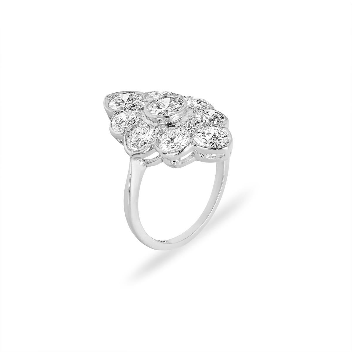 An alluring 18k white gold diamond navette ring. The ring features a marquise shape outline, set to the centre in a rubover setting with a round brilliant cut diamond weighing approximately 0.45ct, H-I colour and SI clarity. Adding to the allure of