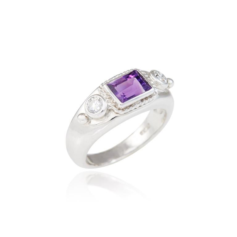 Inspired by the ancients, this ring is in 18 carat white gold and has a tiny roped detail around the central amethyst, with two diamond brilliants and granulated details on the shoulder. Ring available in size N. Can also be made to order in 18