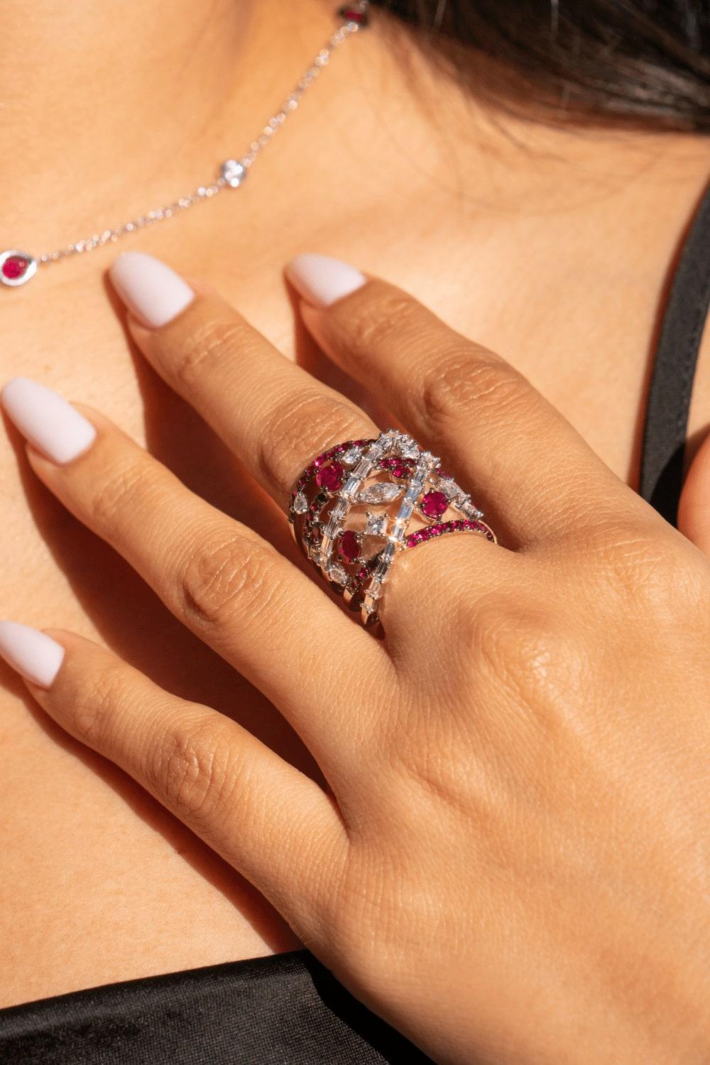 Elevate your style with our captivating White Gold Diamond & Ruby Ring, designed to turn heads with every gesture.

Adorned with a total of 0.81 carats of pear, princess, marquise, and baguette diamonds, the ring exudes elegance and sophistication