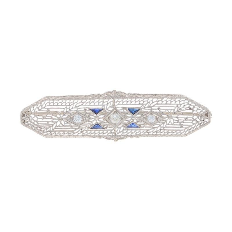 Era: Art Deco

Metal Content: 14k White Gold

Stone Information

Natural Diamonds
Carat(s): .38ctw
Cut: European
Color: H - I
Clarity: SI1 - SI2

Lab Grown Blue Sapphire
Treatment: Heating
Cut: Triangle

Total Carats: .38ctw

Style: Bar