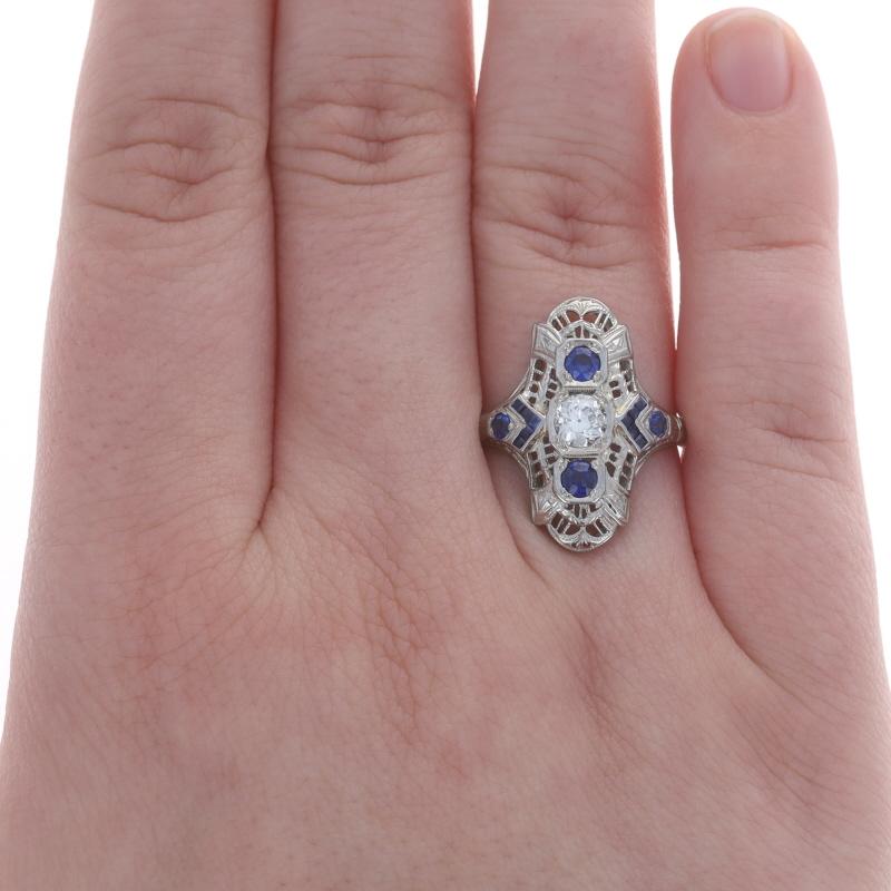Size: 6 1/2
Sizing Fee: Up 2 sizes for $50 or Down 1 size for $35

Era: Art Deco
Date: 1920s - 1930s

Metal Content: 18k White Gold

Stone Information
Natural Diamond
Carat(s): .38ct
Cut: European
Color: I
Clarity: SI2

Natural Sapphires
Treatment: