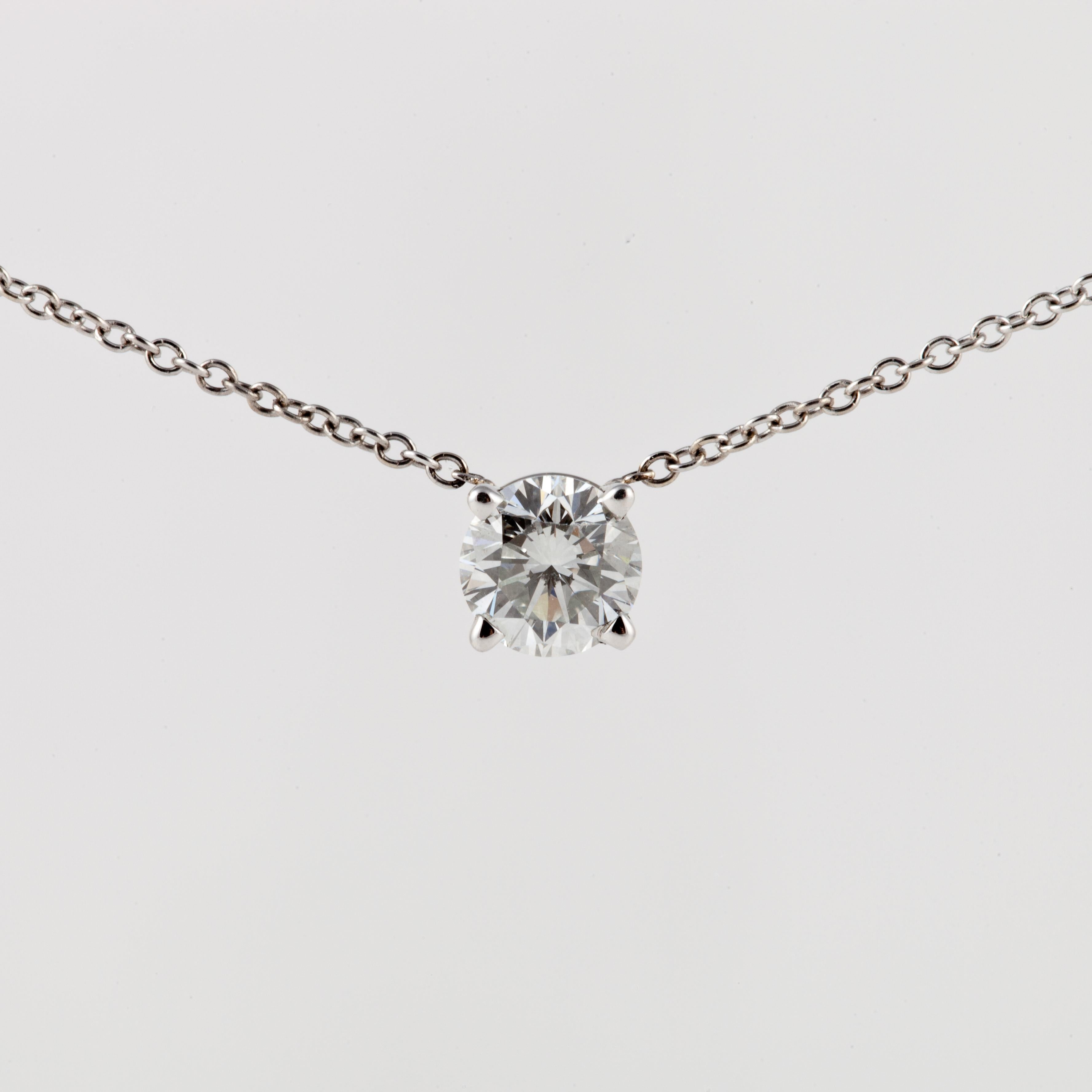 Classic diamond solitaire necklace set in 18K white gold.  The diamond is 0.70 carats; G in color and VS1 in clarity.  Chain measures 17-1/2