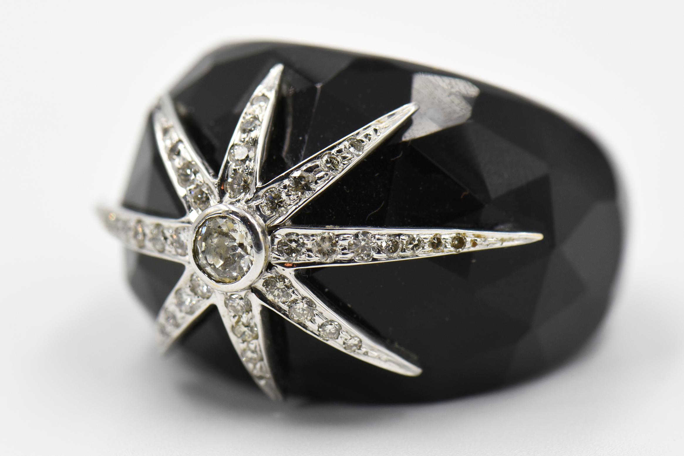 Dramatic faceted black onyx domed ring decorated with a 18k white gold and diamond star burst design.

The ring measures 1.25