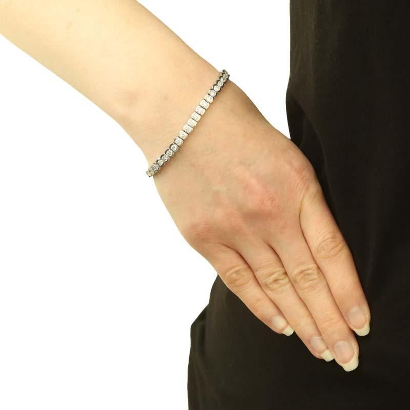 Metal Content: 14k White Gold

Stone Information

Natural Diamonds
Carat(s): 6.75ctw
Cut: Round Brilliant
Color: F - G
Clarity: VS1 - VS2

Total Carats: 6.75ctw

Style: Tennis
Fastening Type: Tongue Box Clasp with Fold-Under Safety