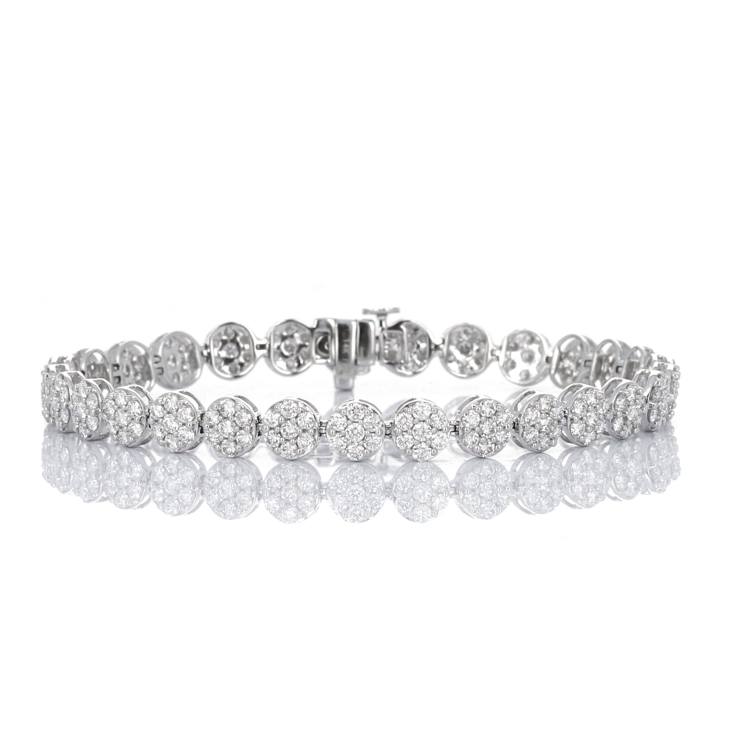 14 karat white gold diamond tennis bracelet. The diamonds are set to create an iillusion. Each link is composed of smaller diamonds, making it look like one large stone. There is an estimated 5.00 carats total weight in diamonds.
